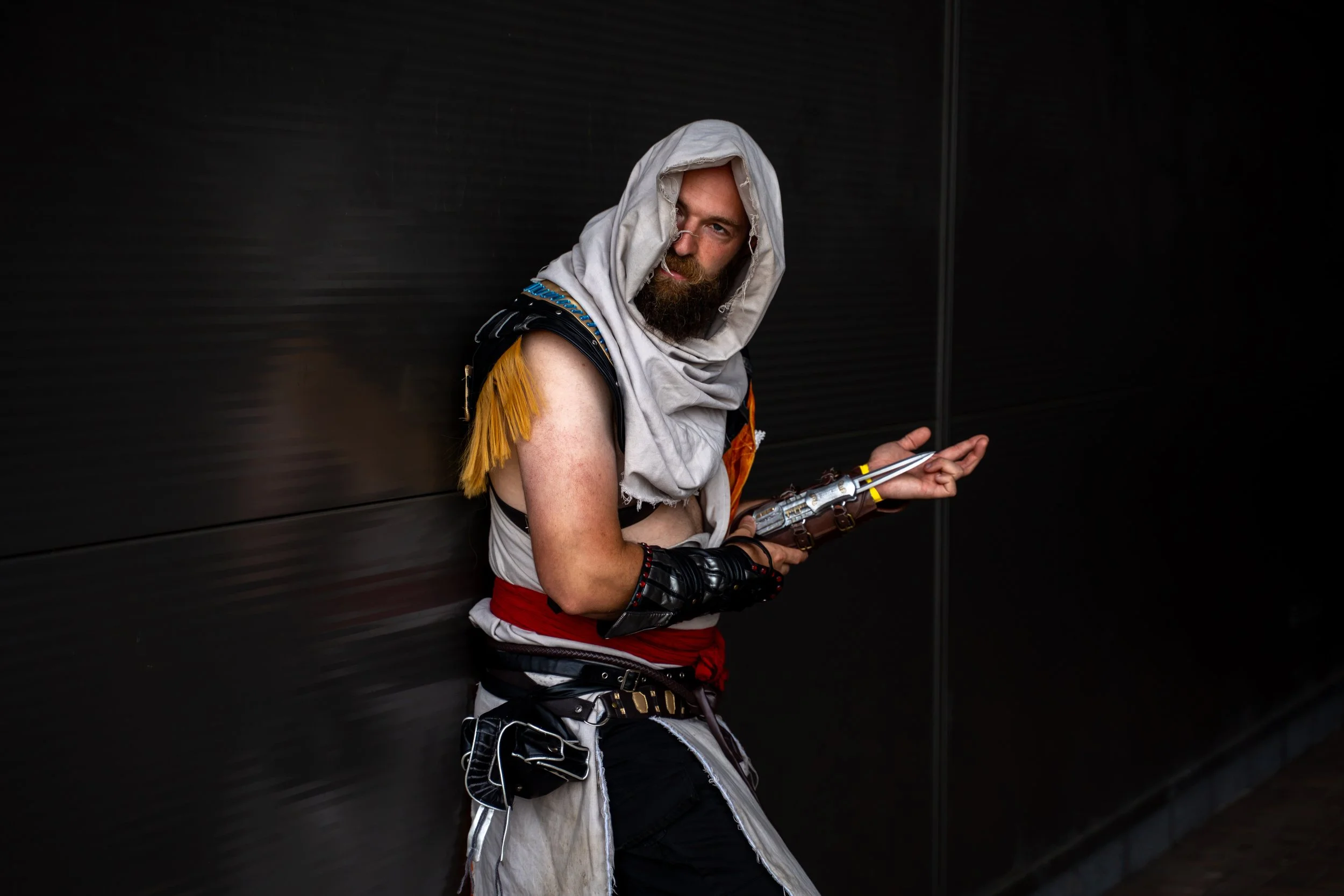 Assassin’s Creed cosplayer wearing a white hooded costume