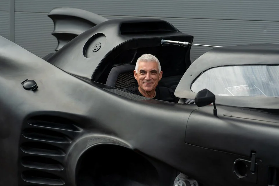 Carl Newman posing inside the 1989 Batmobile