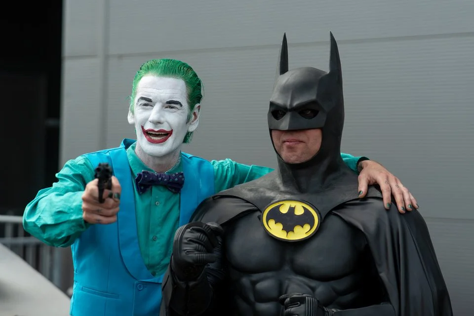 Joker and Batman cosplayers posing together