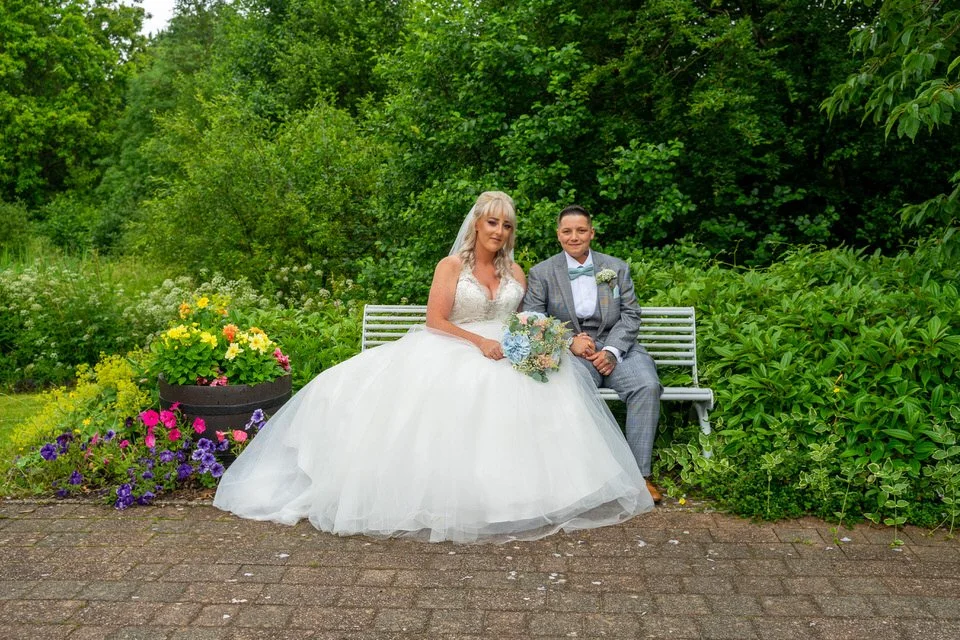 Newlywed couple sharing a relaxed moment during their Caerphilly wedding