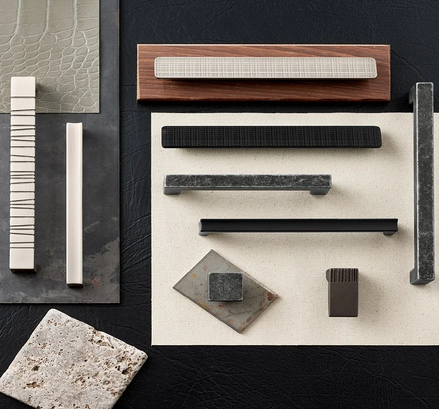 Assorted cabinet handles and tiles on various textured surfaces