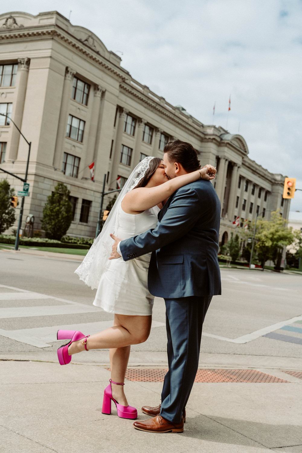 Documentary kiss in downtown Toronto by Ontario wedding photographer Amare Studios