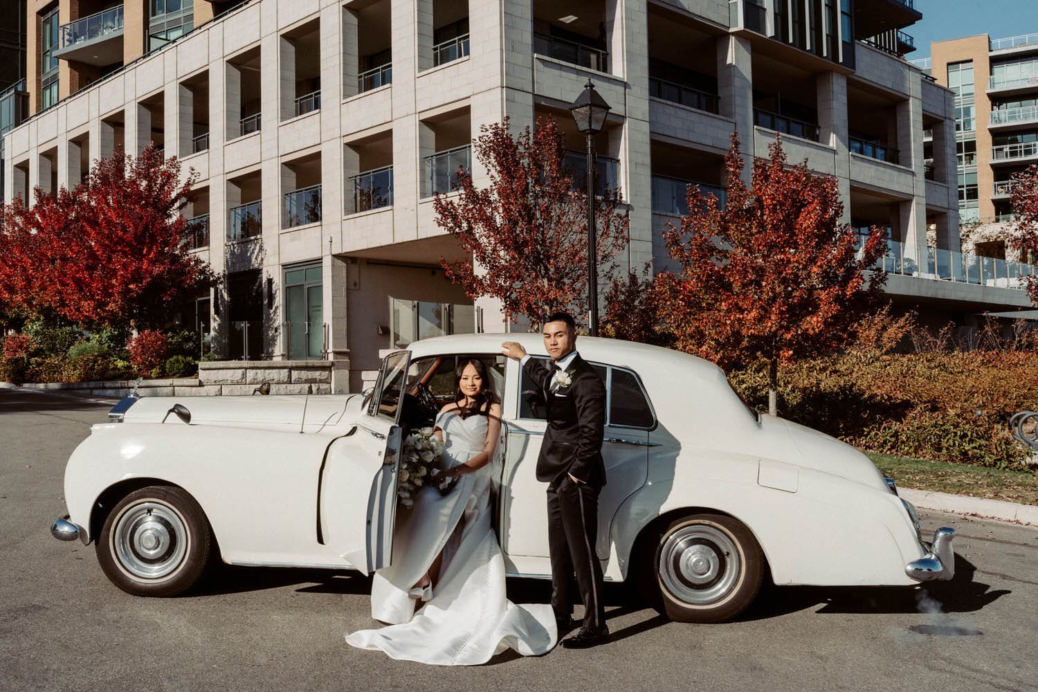 Bride and groom with vintage car at Pearle Hotel in Burlington, captured by Ontario wedding photographer Amare Studios