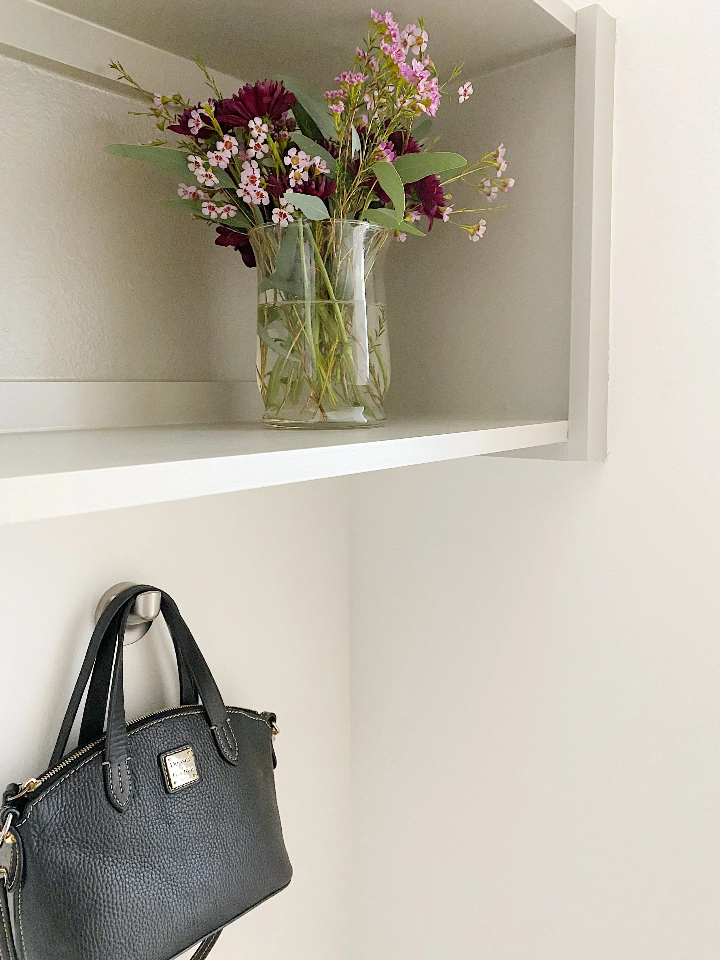 Organized entryway with baskets, hooks, and a bench for everyday essentials
