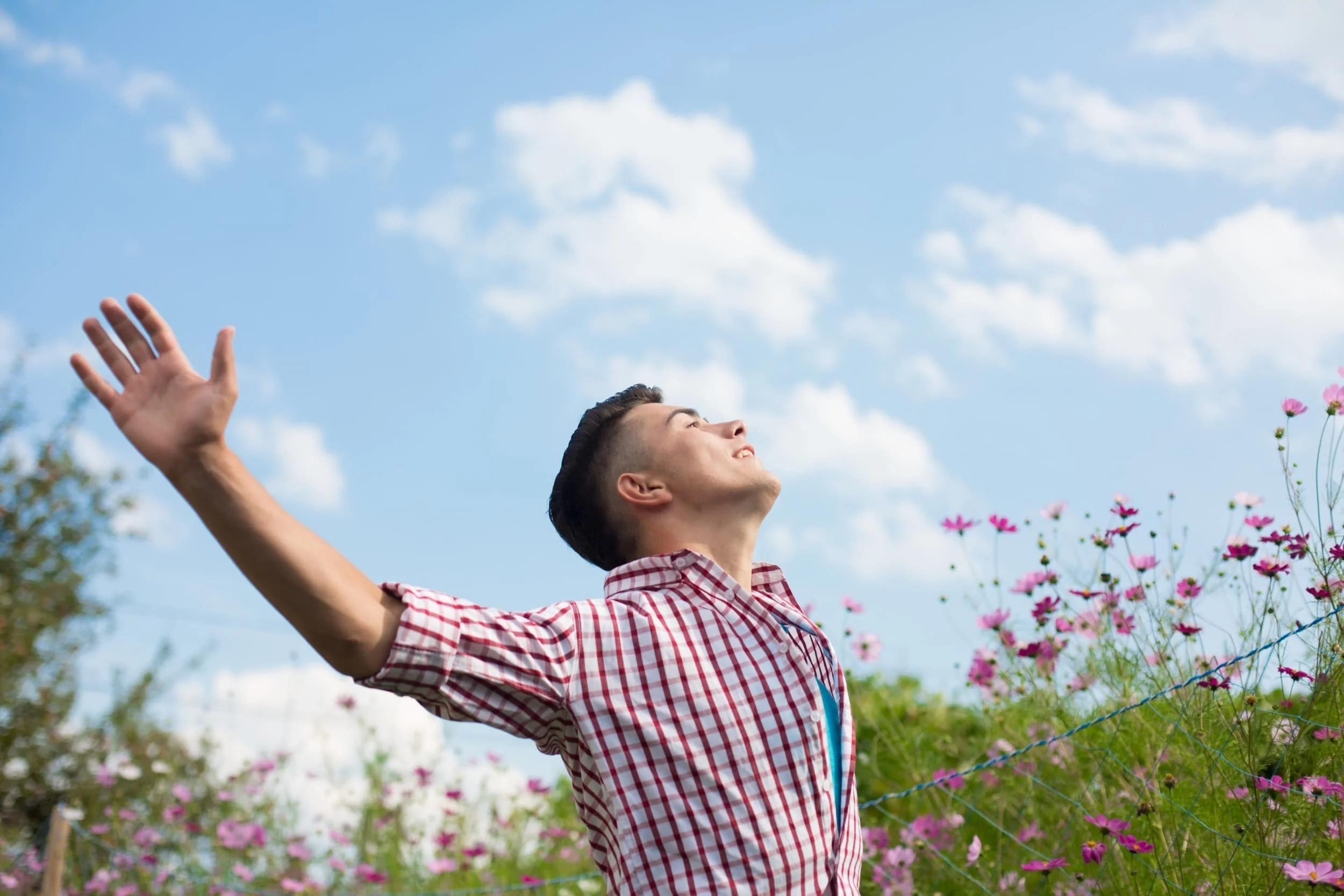 Confident gay man feeling happy and free outside.