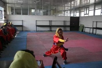 Shahnaz's peers watching her practice.