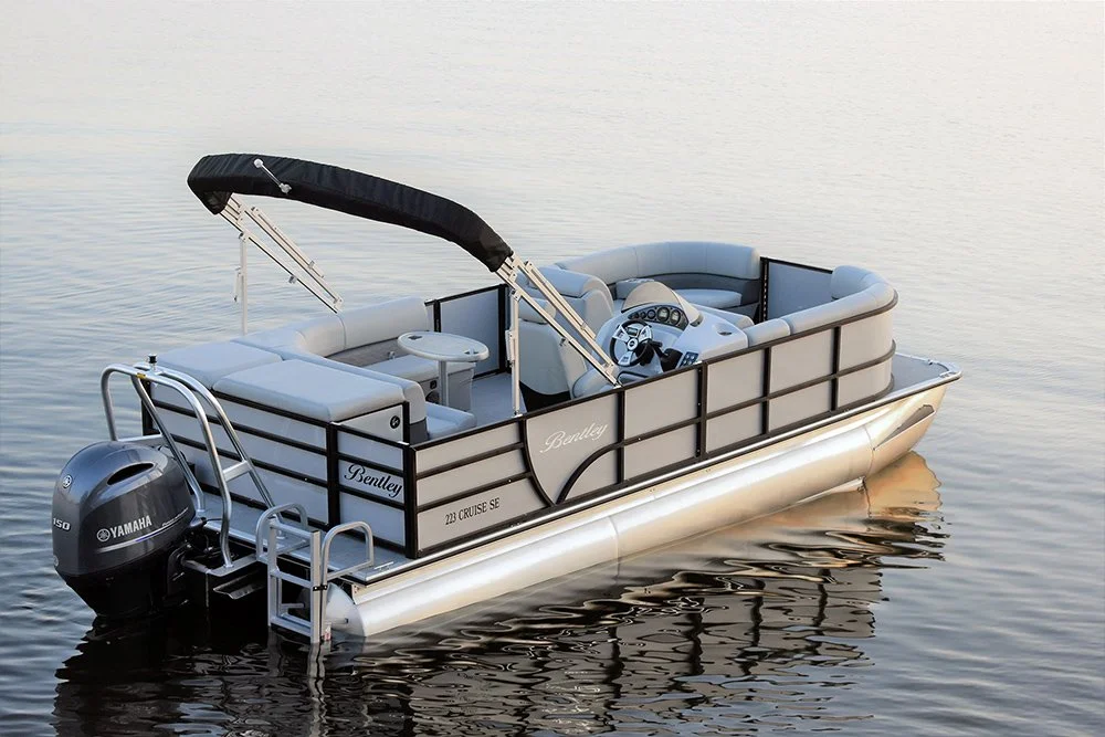 Pontoon boat on calm water with a Yamaha outboard motor and canopy.