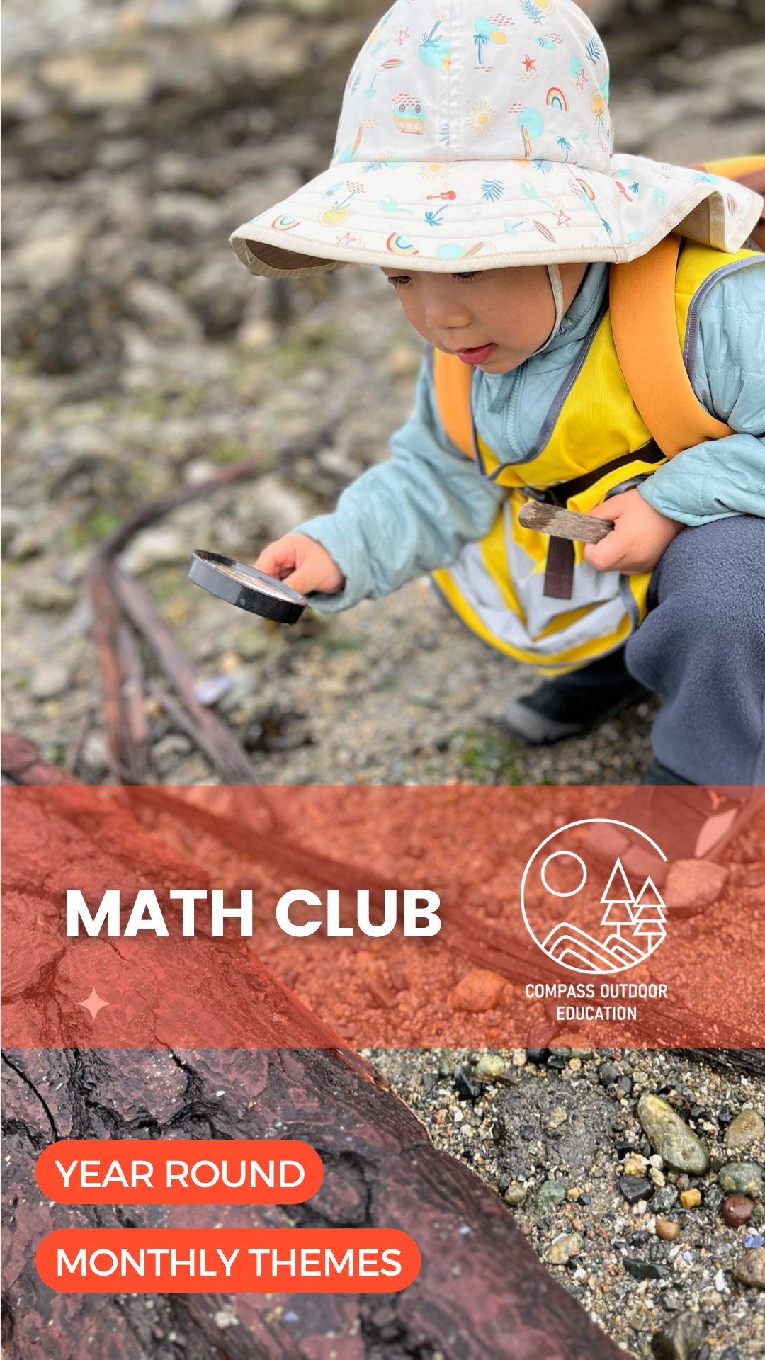 A young child in a sun hat and yellow Compass safety vest using a magnifying glass to examine pebbles and rocks on a Vancouver beach during Compass Outdoor Education Math Club.