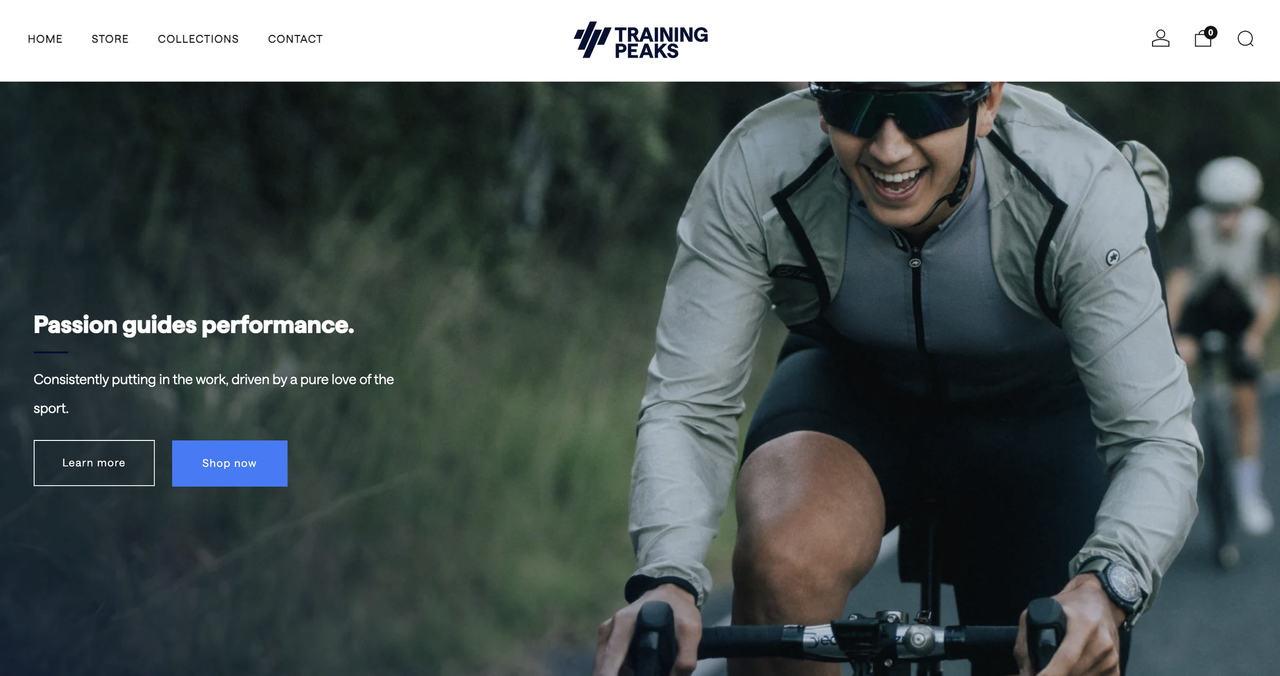 A person in sunglasses and sports gear happily riding a bicycle outdoors with others in the background.
