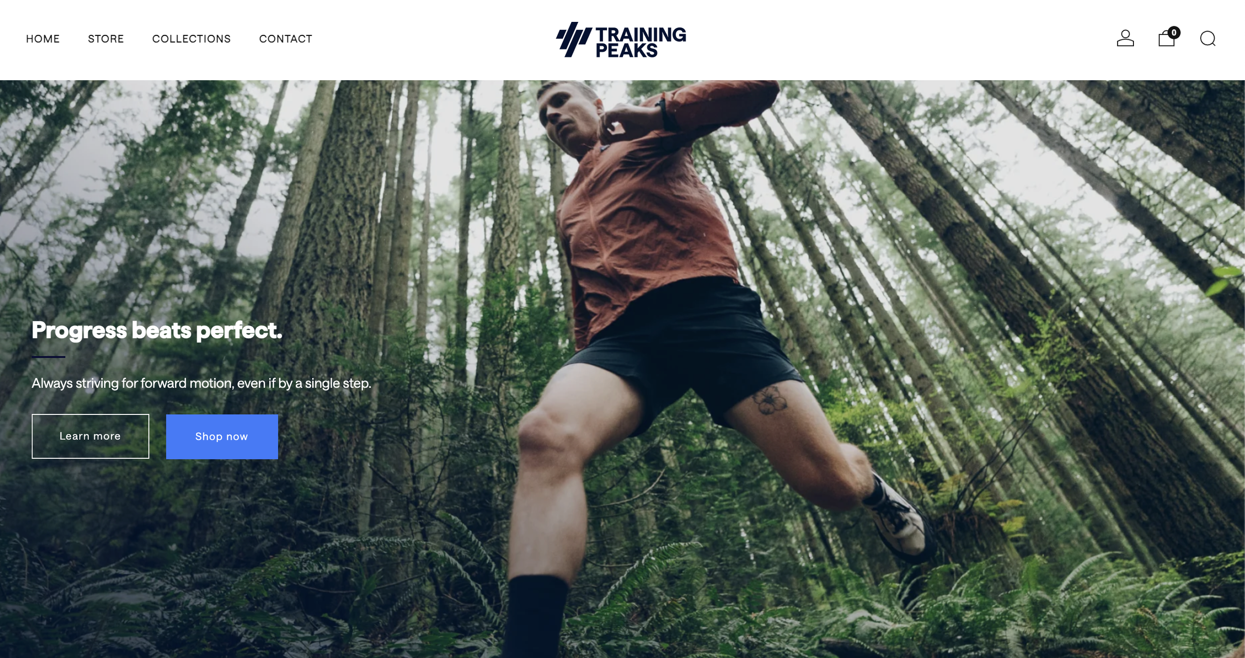 A person in athletic clothing, including a rust-colored jacket and black shorts, running through a dense forest with tall trees and green foliage, captured from a low angle.