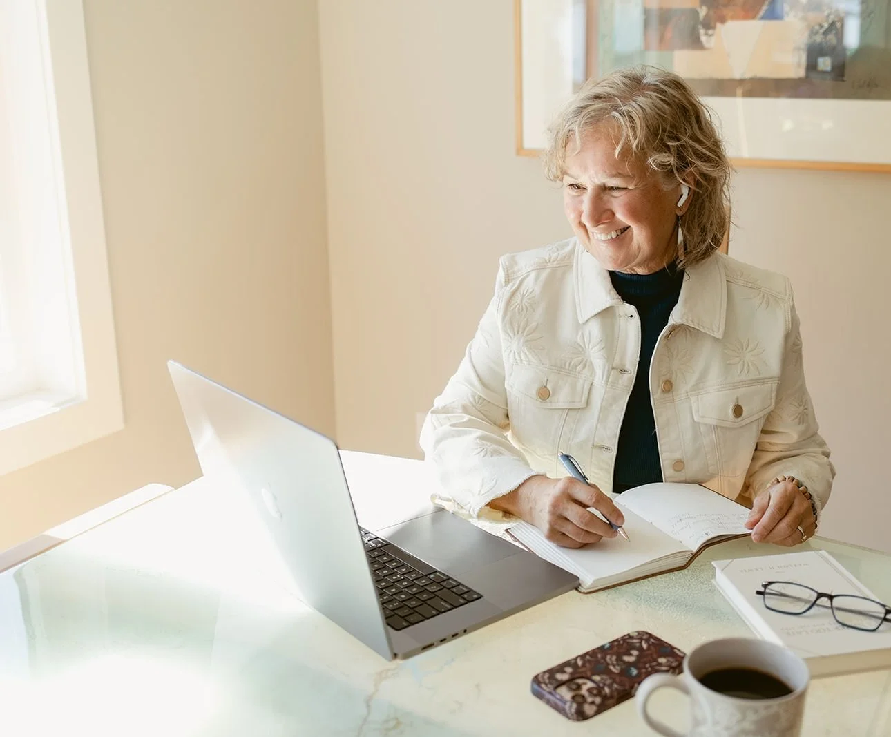 Cathy Fitzgerald looking at laptop and smiling.