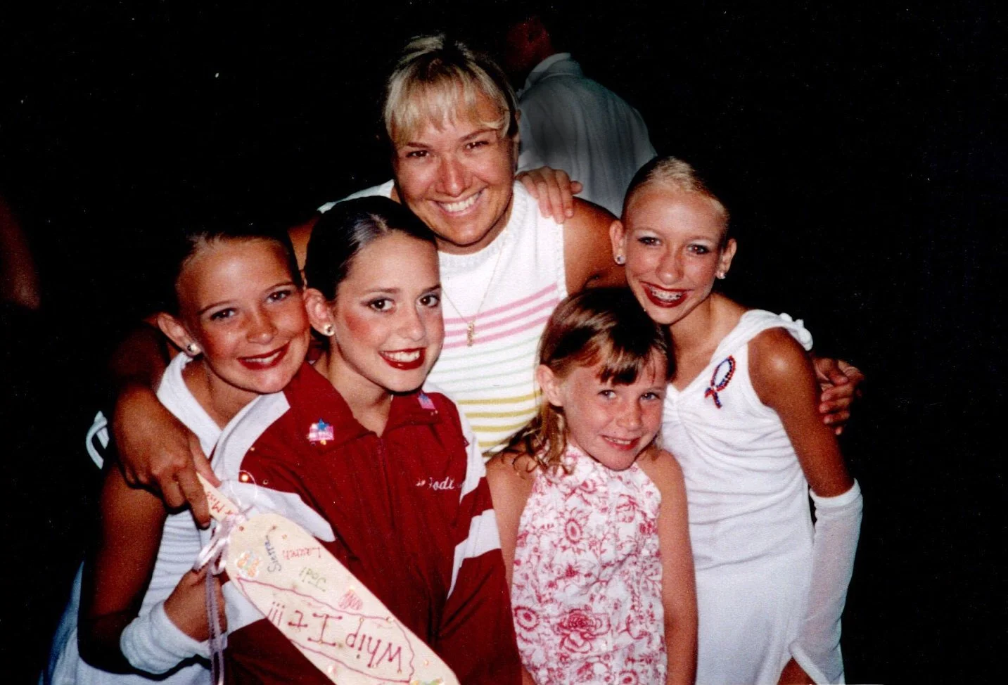 Cathy Fitzgerald hugging dance students at her dance studio