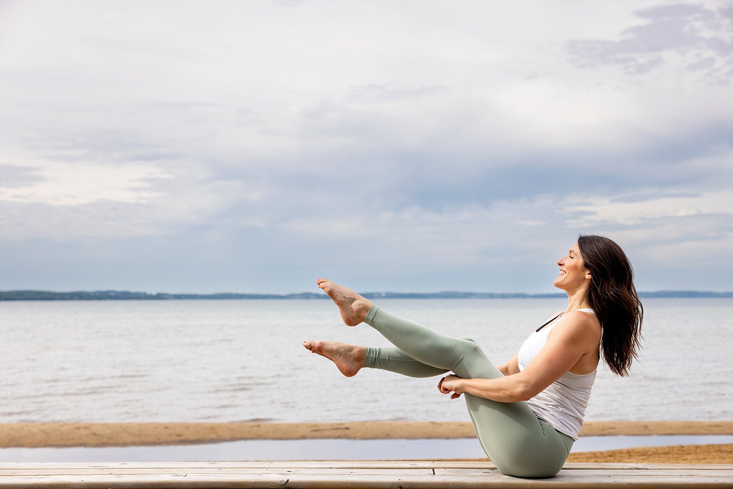 Yoga instructor posing in front of Lake Michigan for a branding photo shoot