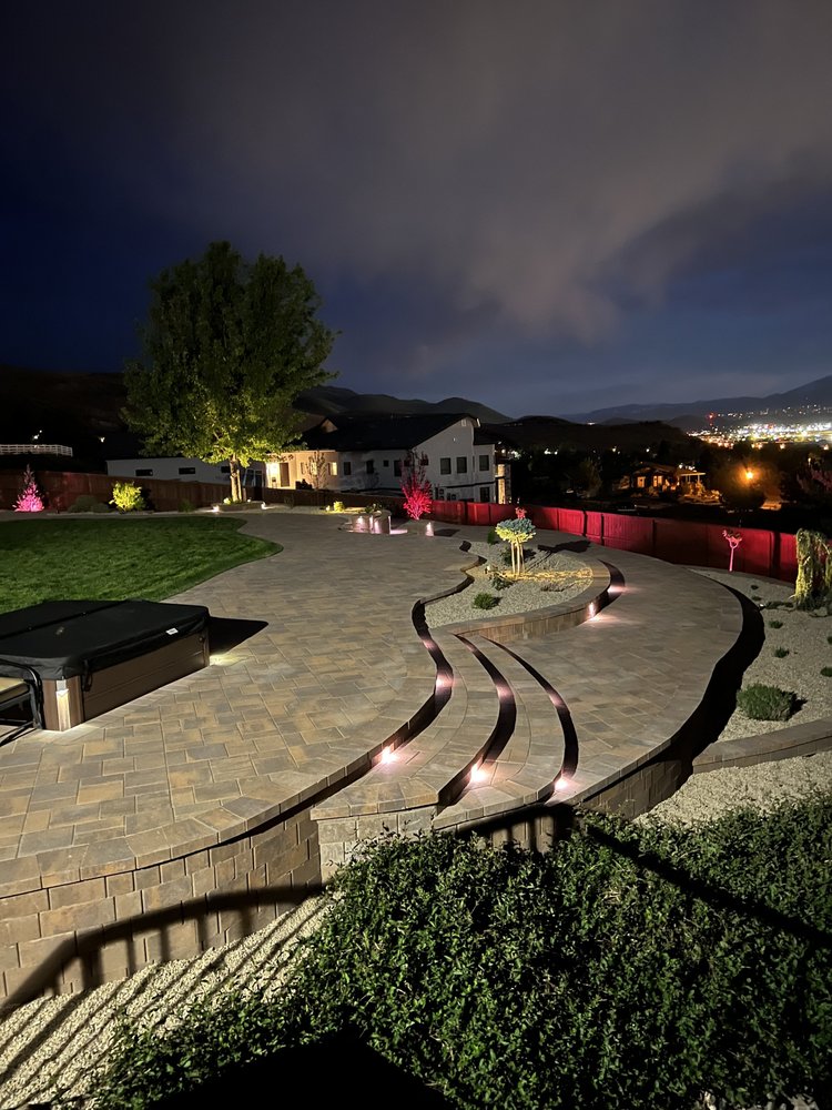 Curved stone steps with built-in lights at night