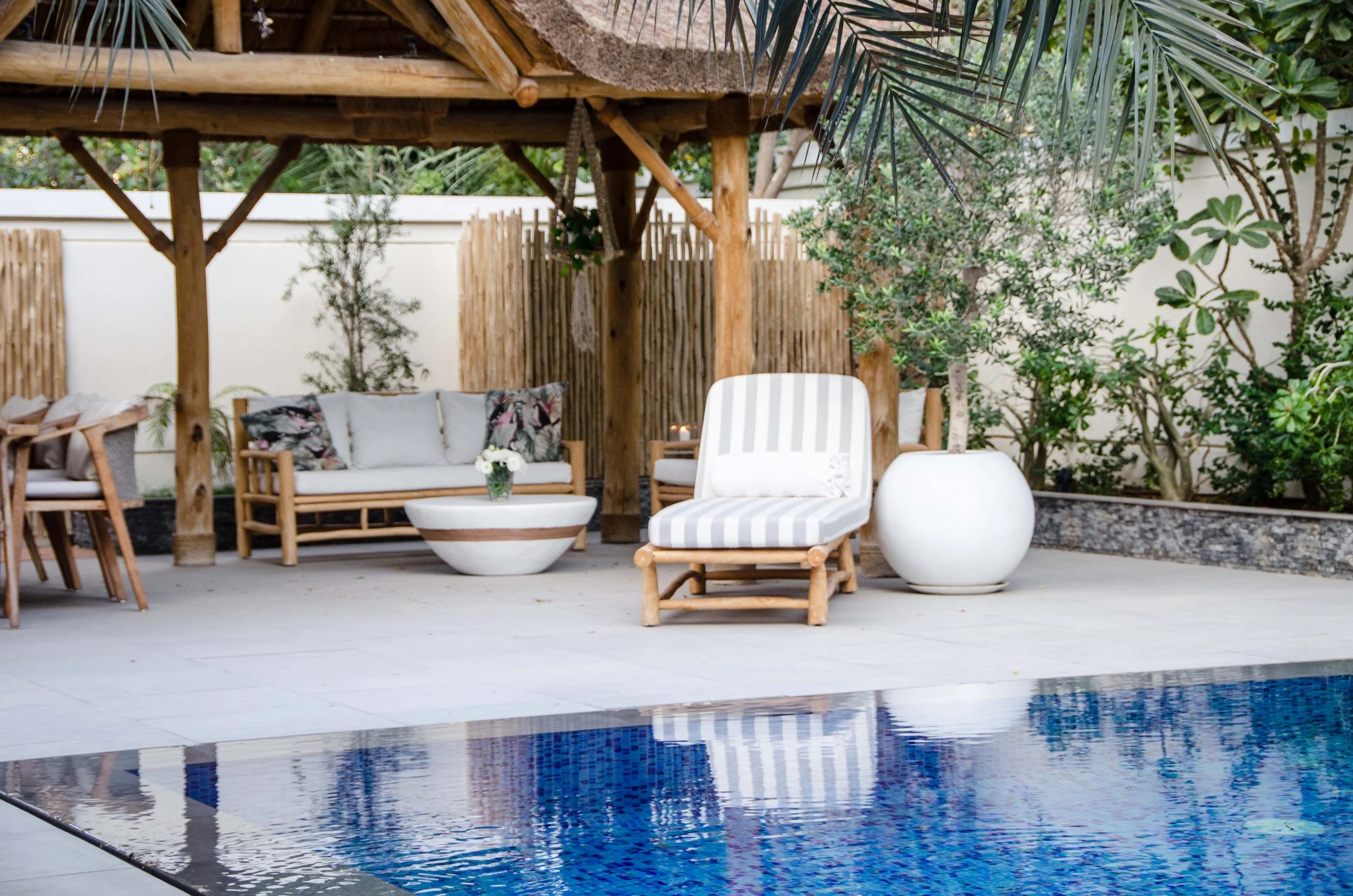 Cabana style space with lounger overlooking the beautiful pool. 