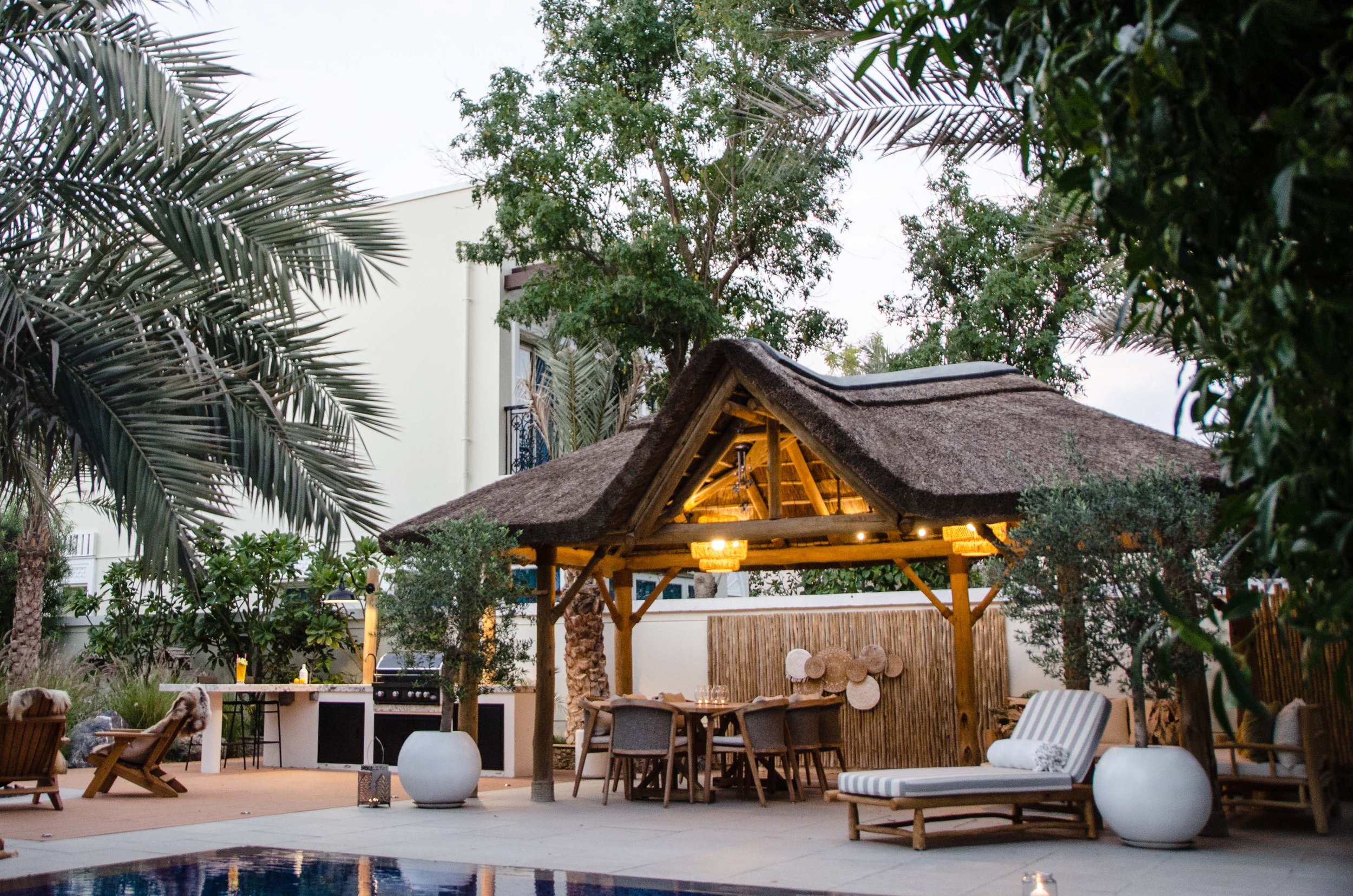 Thatched gazebo entertainment area creating a cool space in the dubai heat. 