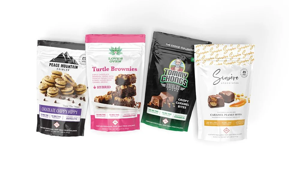 Four different cannabis-infused snack packages including chocolates and brownies.