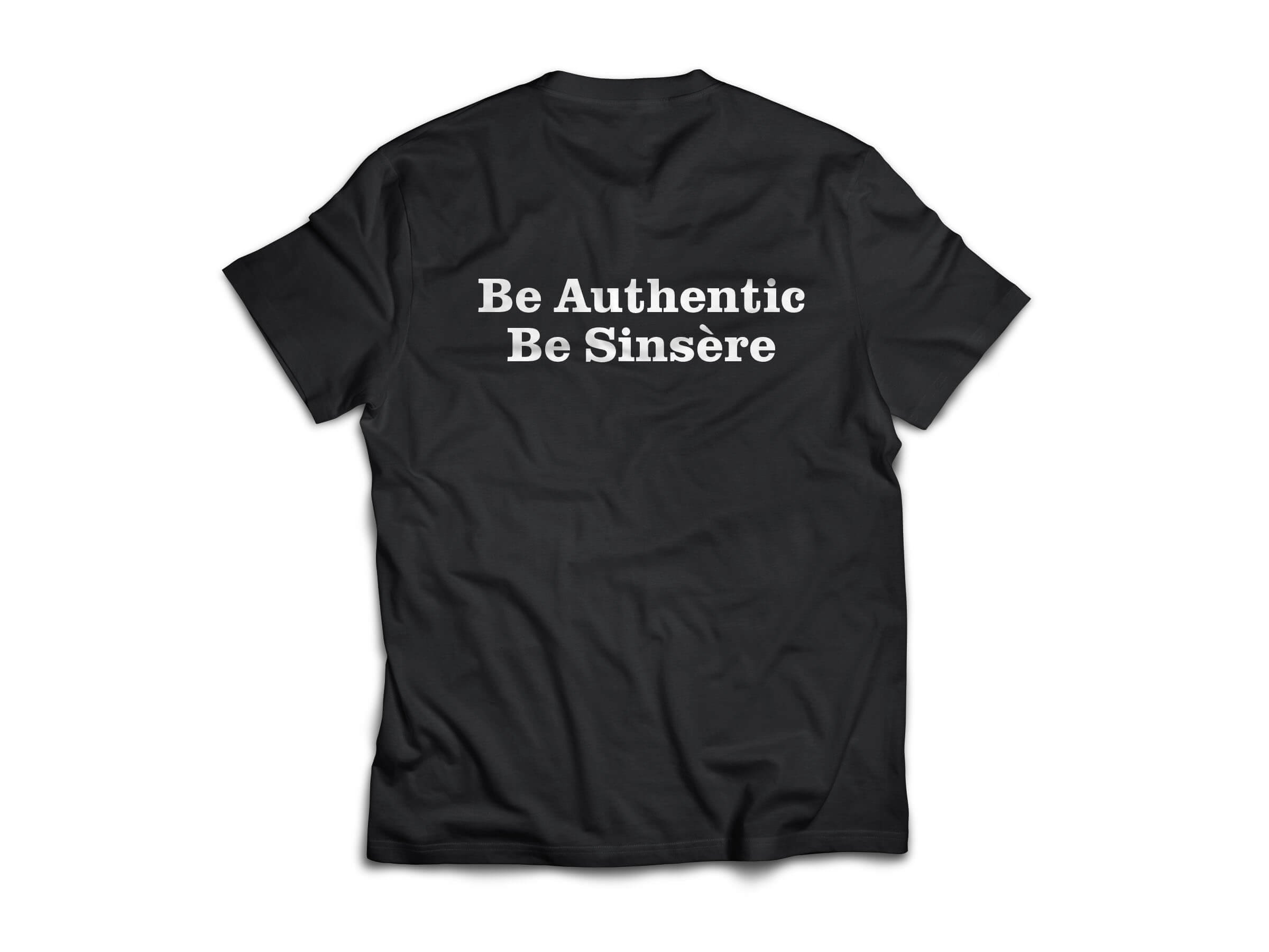 Black T-shirt with white text that says 'Be Authentic Be Sincere' printed on the back.