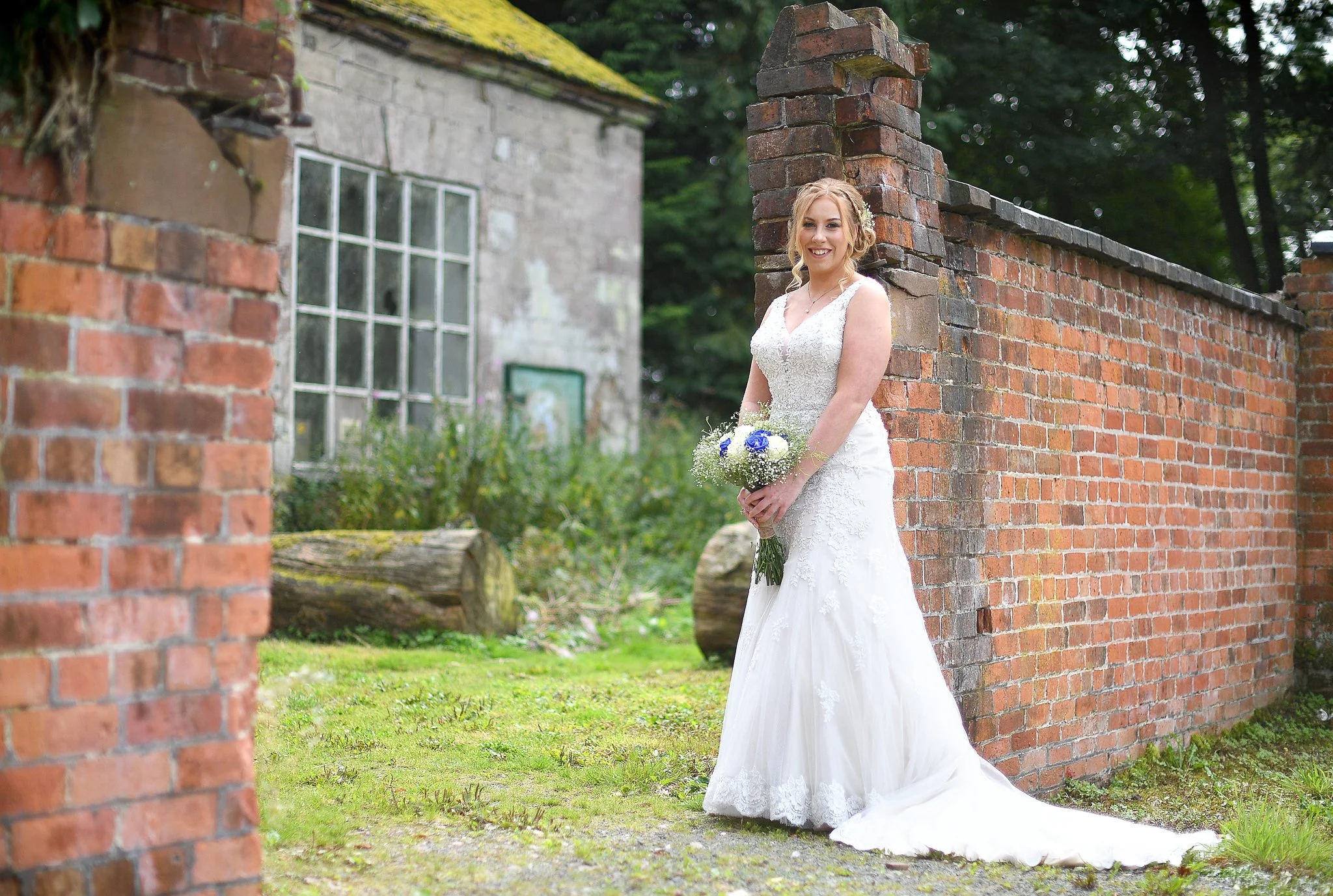 bride smiles at the camera during a bridal preperation shoot at sugnall walled garden near eccleshall in staffordshire photographed by wedding photographer chris peach photography