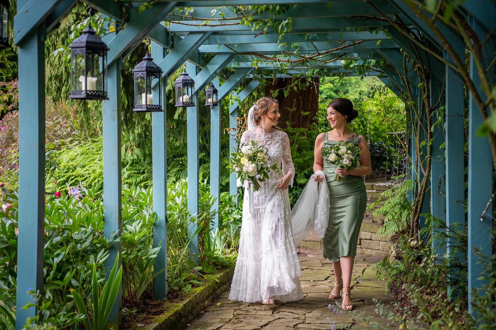 Bride and maid of honour walk around the grounds at dunwood hall estate wedding venue photographed by UK wedding photographer chris peach photography