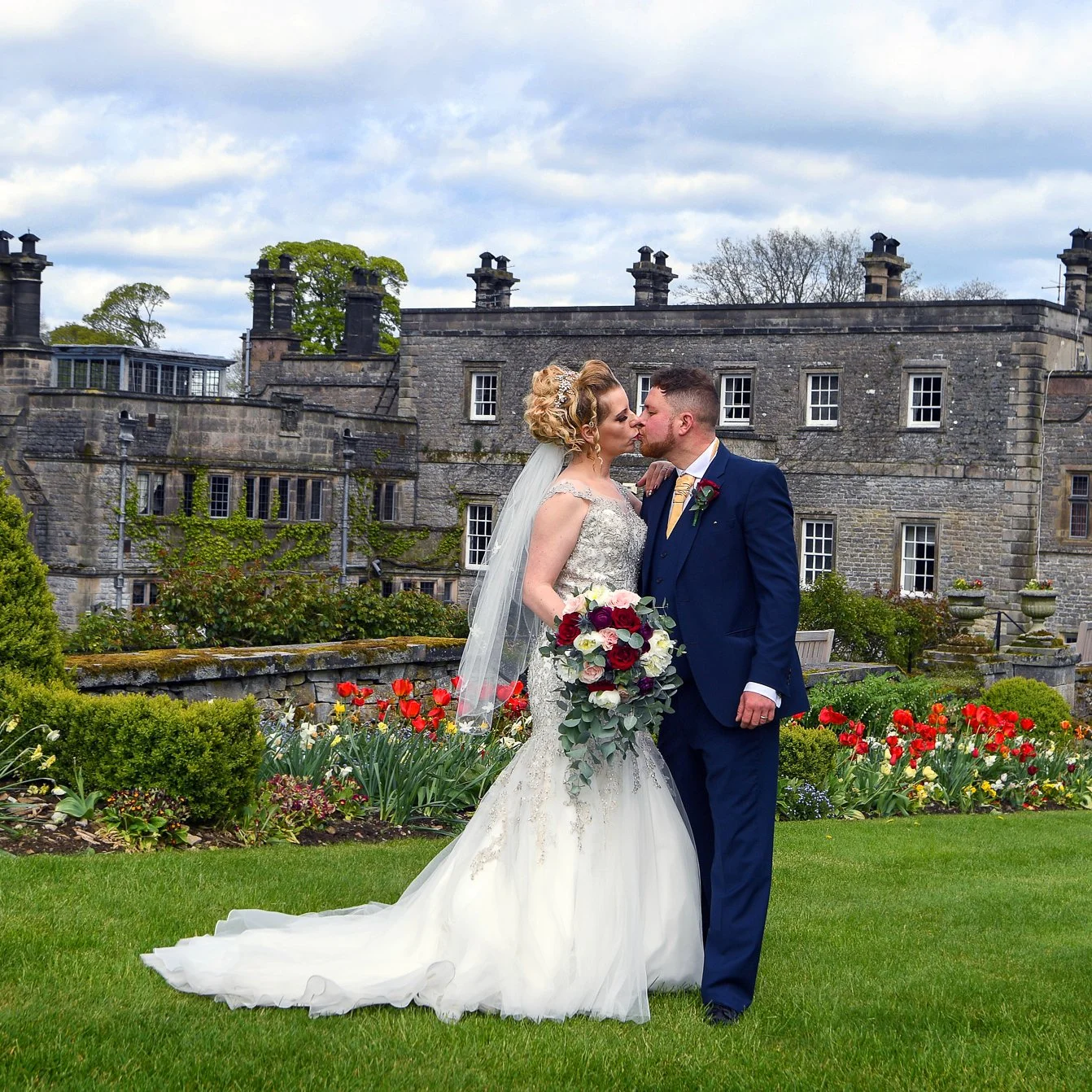 newlywed married couple kissing for posed wedding album in the peak district photographed by wedding photographer chris peach photography