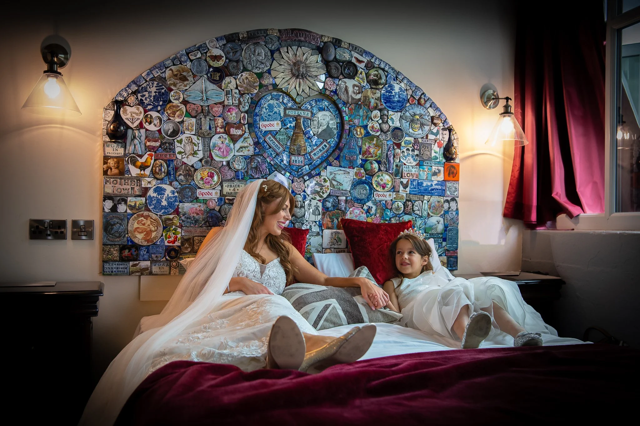 bride and daughter share a moment in the honeymoon suite at spode potbank wedding venue photographed by UK wedding photographer chris peach photography