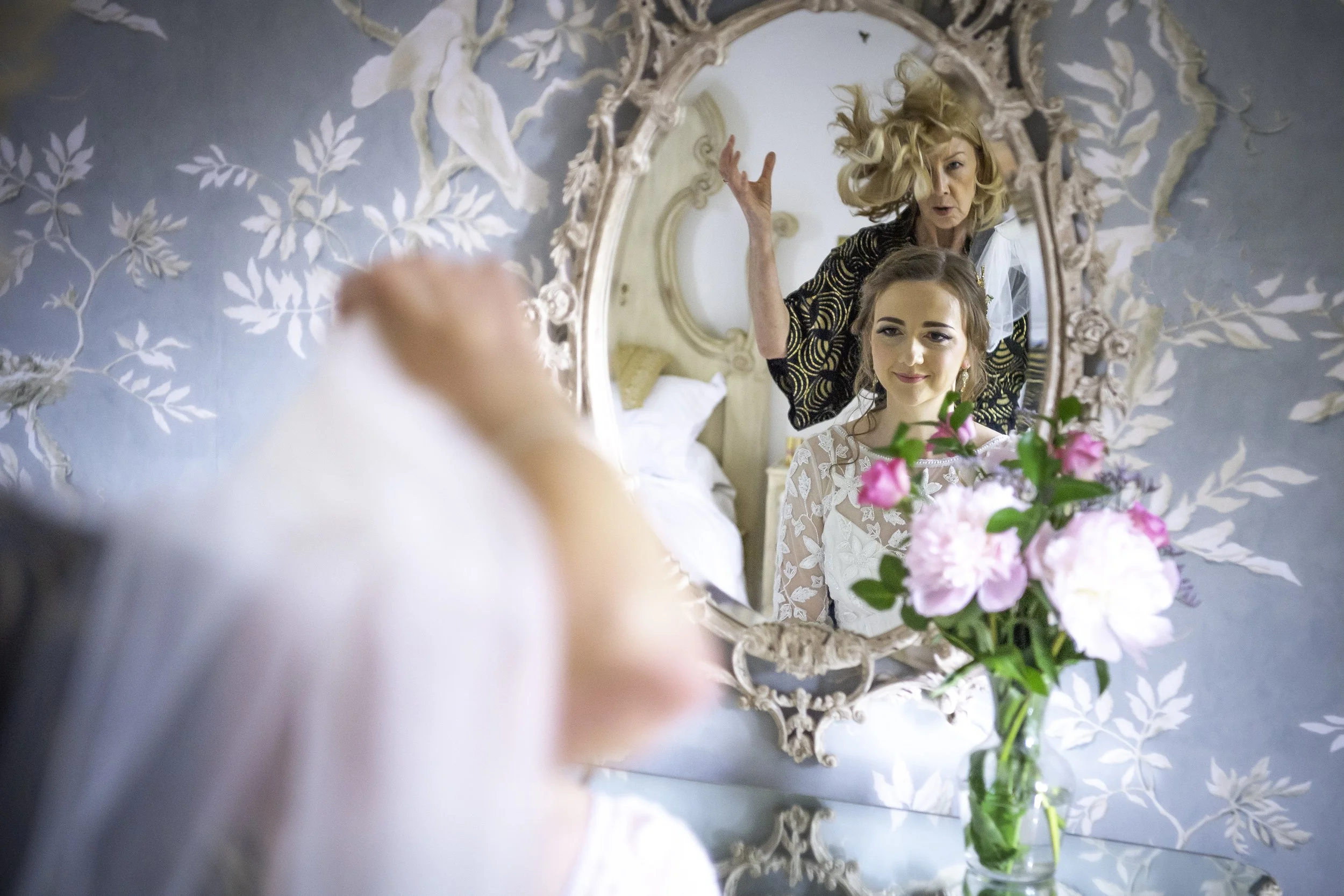bride having her hair and makeup done before her wedding day at dunwood hall estate near leek in staffordshire photographed by wedding photographer chris peach photography