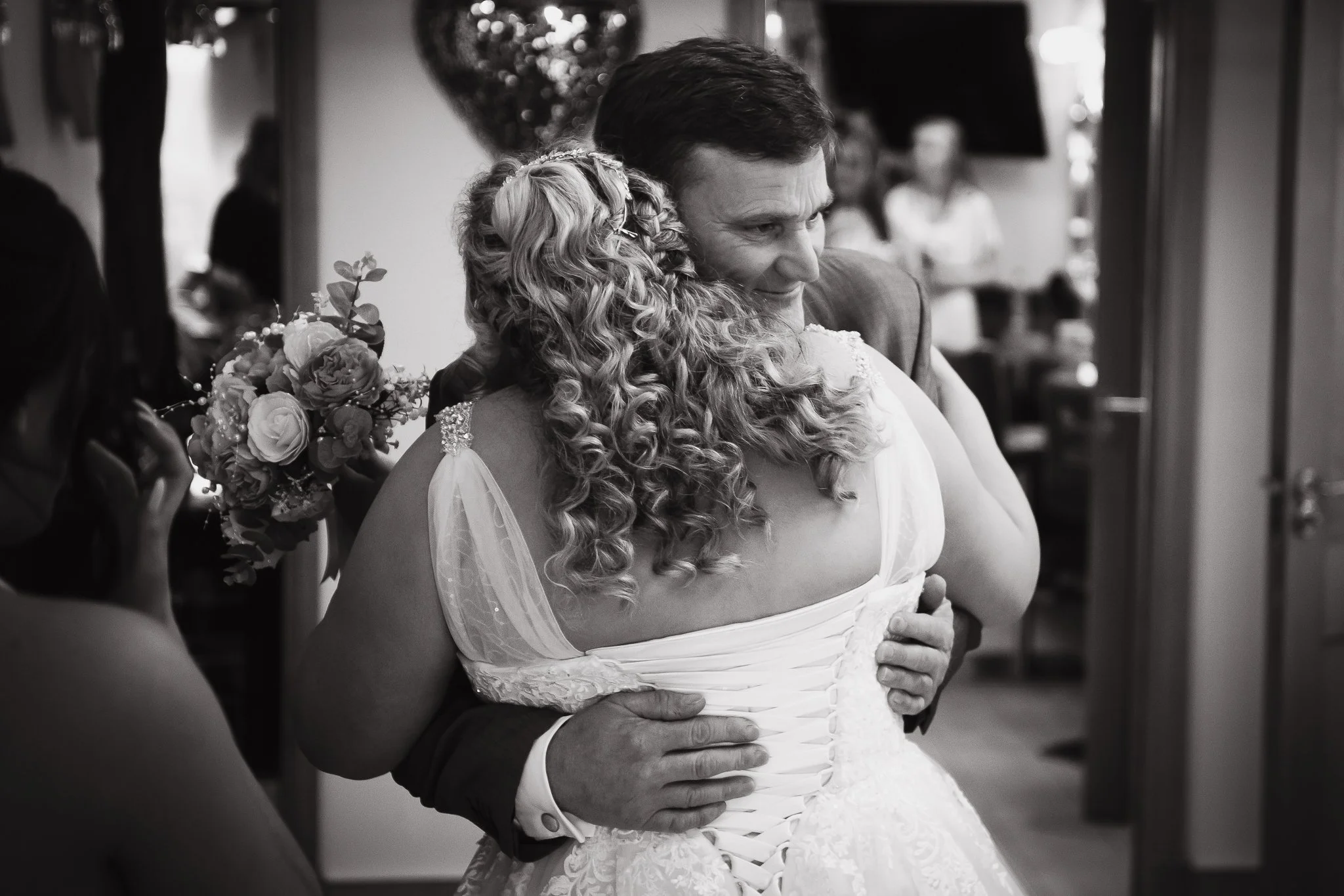 bride and father of the bride share a hug photographed by UK wedding photographer chris peach photography