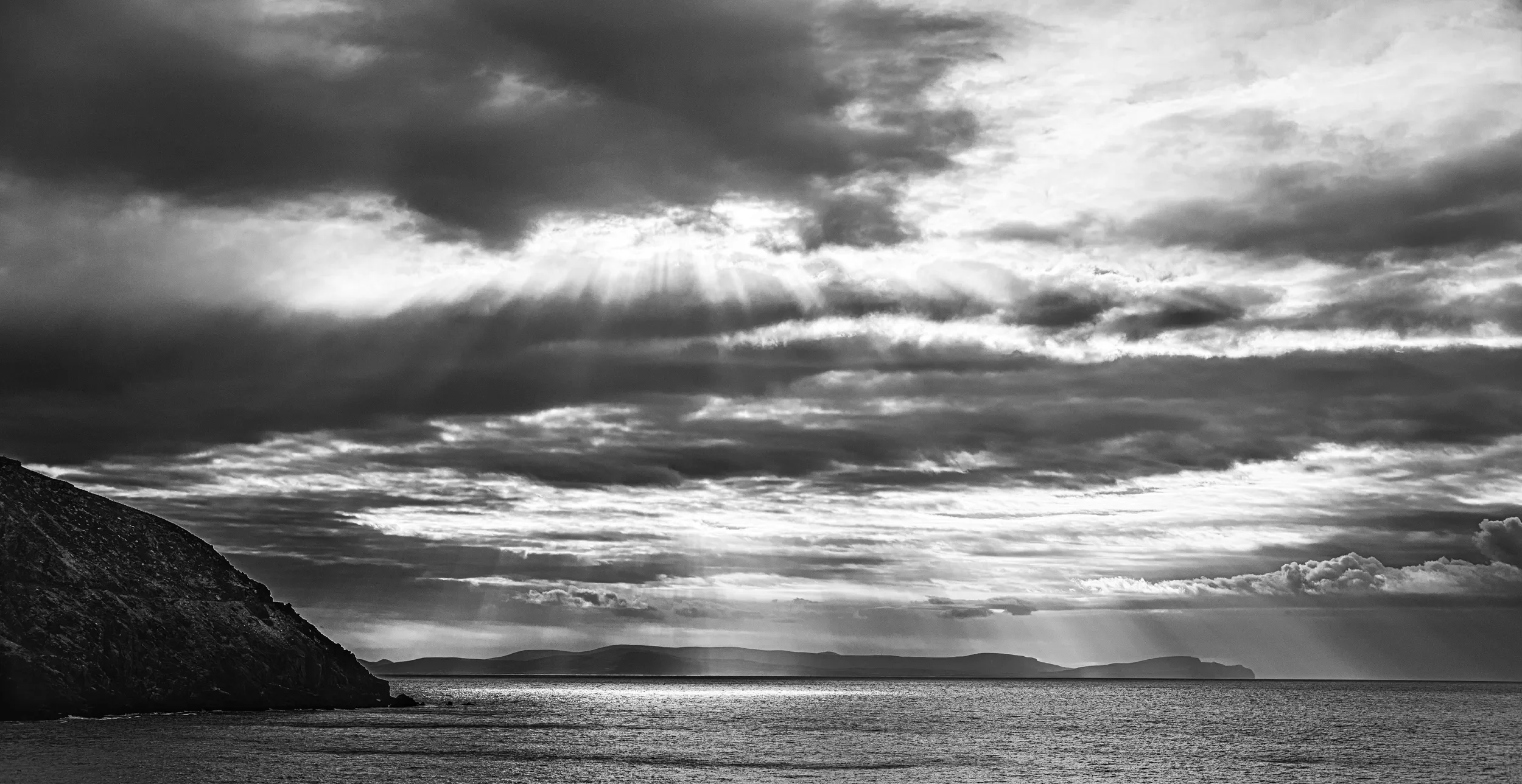   Through the Clouds   / Dramatic sunbeams illuminating distant shores across the bay / Dingle Bay, 2022   KYD-002