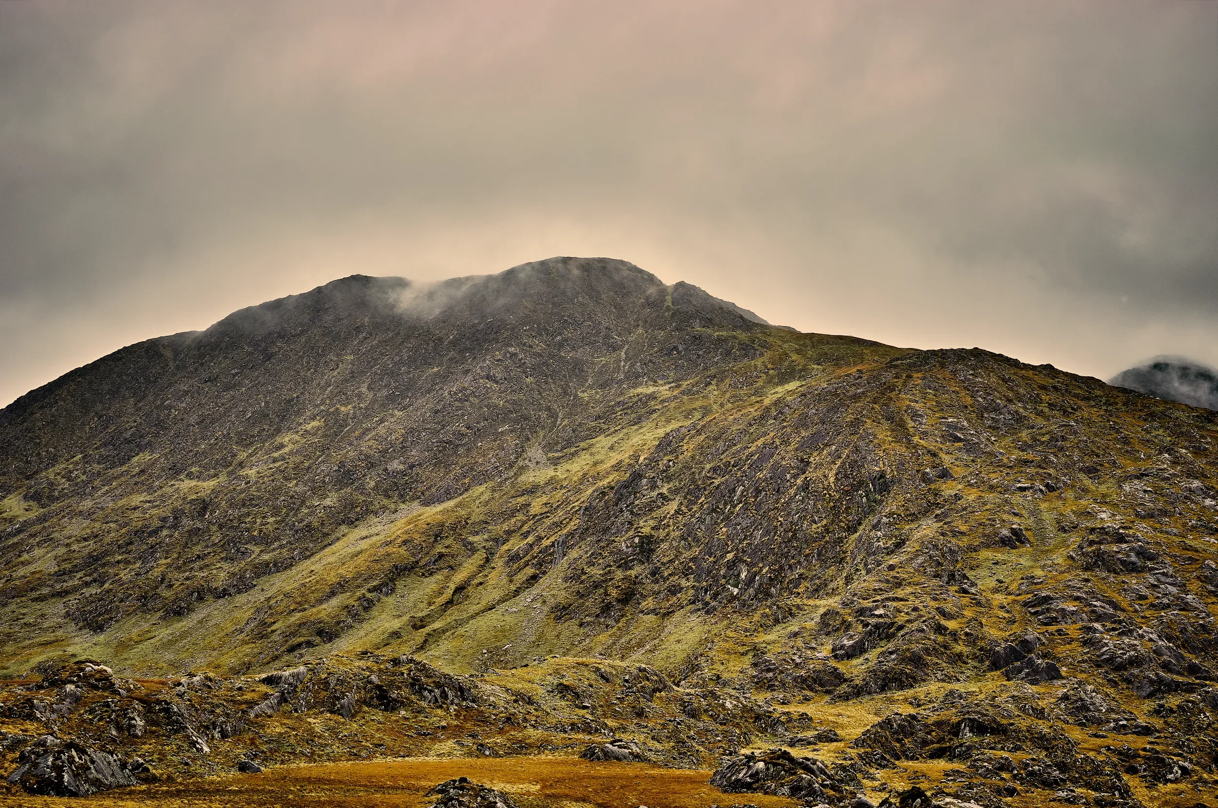   A Touch of Amber   / Sculpted mountain slopes illuminated by soft golden light/ Killarney National Park, 2024   KYI-070