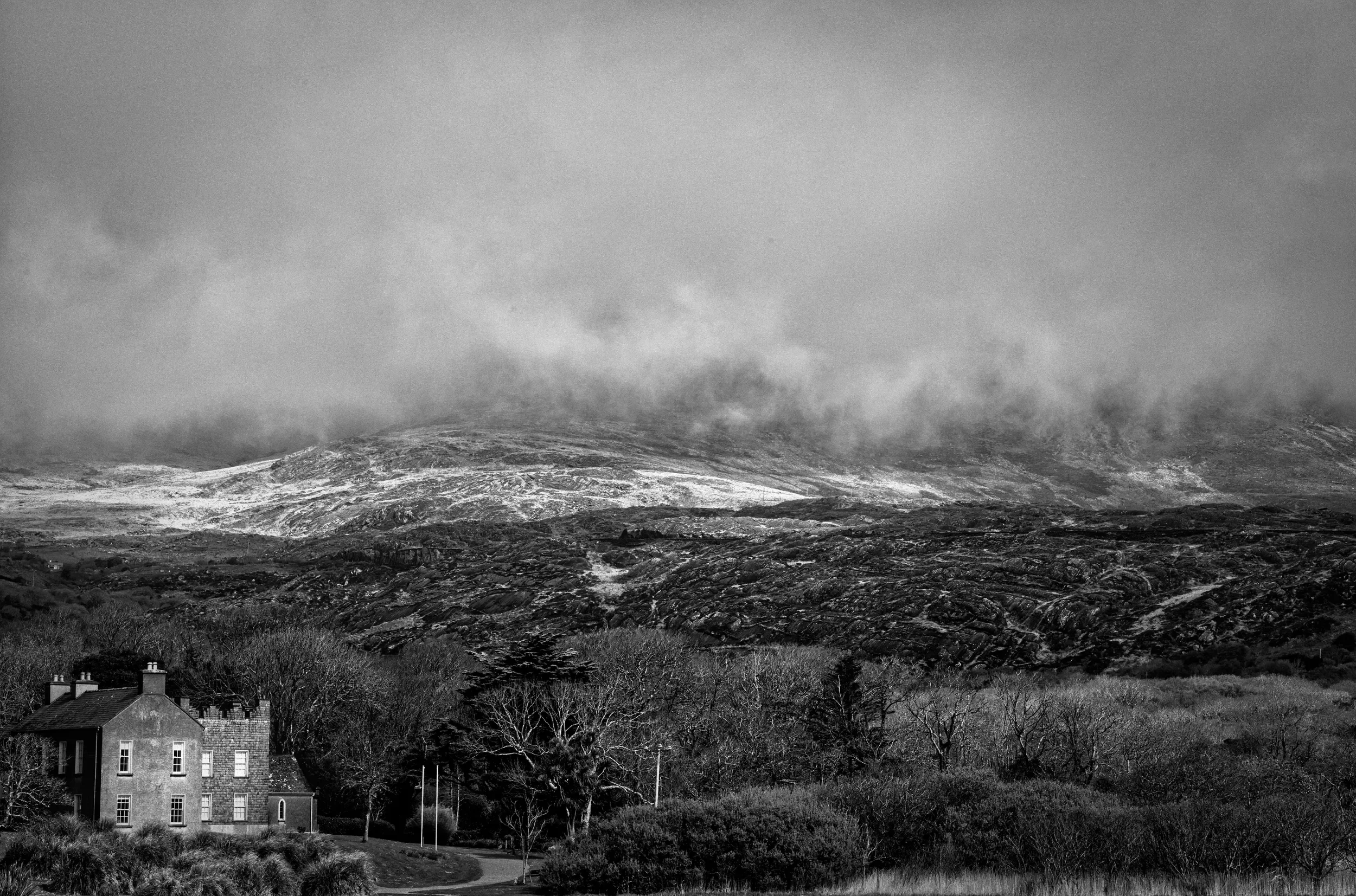   Beneath the Mountains   / Historic Derrynane House dwarfed by the mist-shrouded mountains / Ring of Kerry, 2022   KYI-065