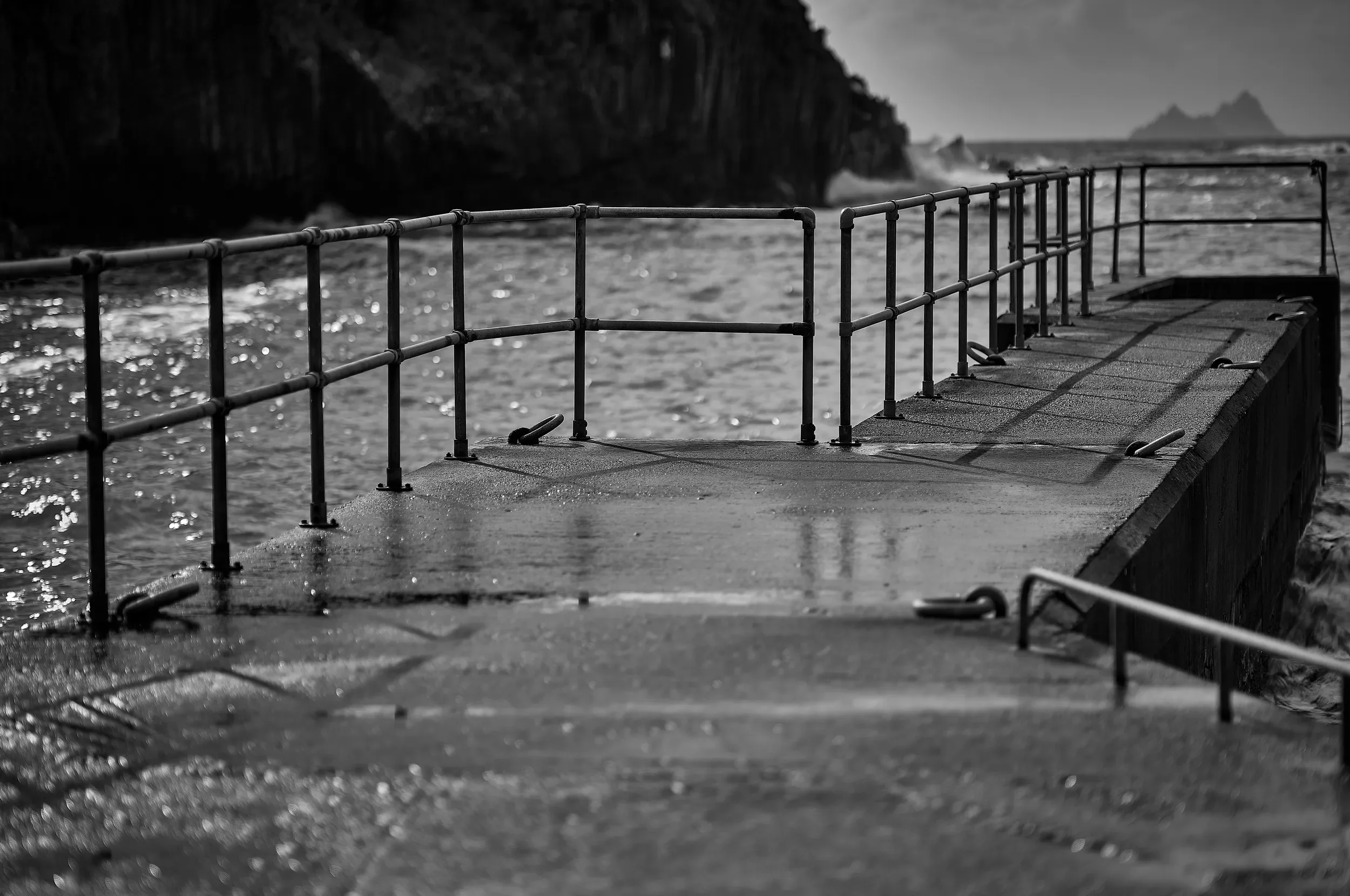   Lines of Light  / Sunlight tracing the railings across the weathered pier / Skellig Ring, 2025   IRP-005