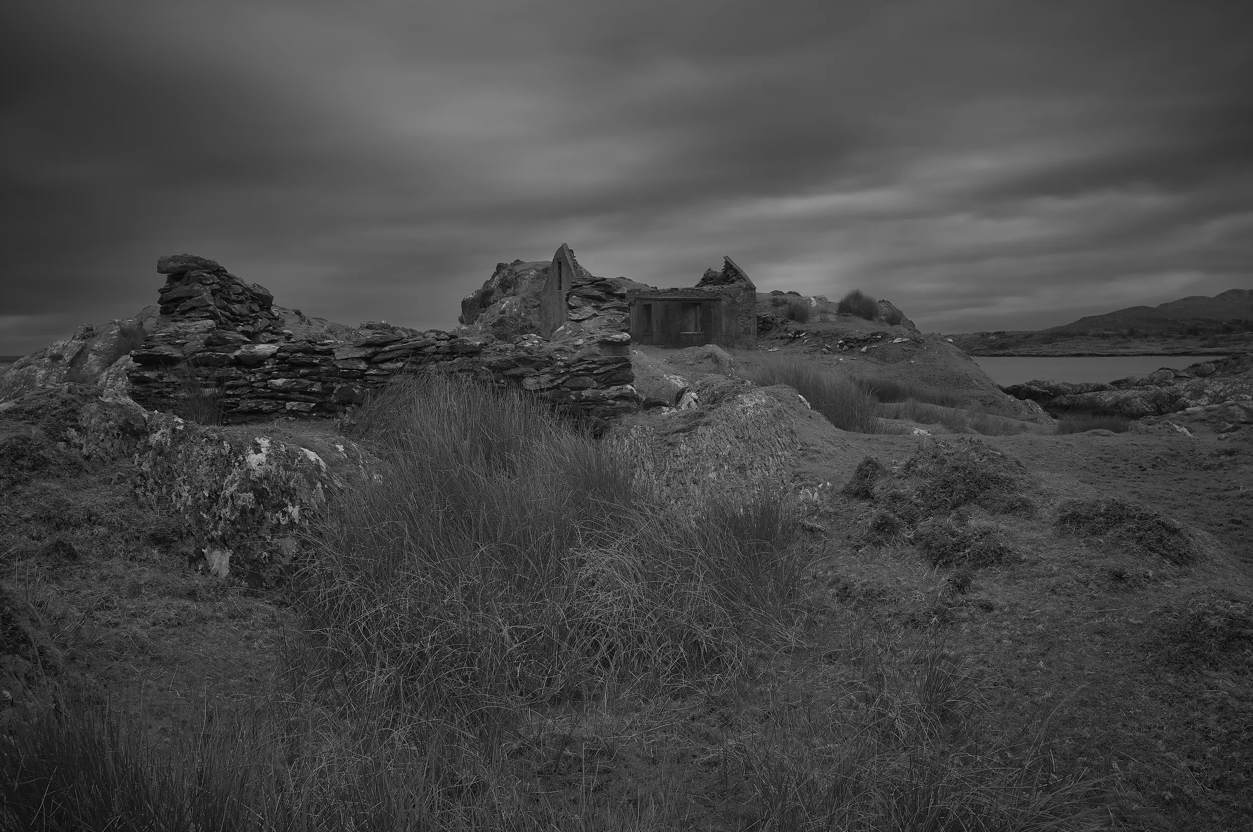   Beyond the Harbour Wall   / Curved stonework framing a secluded inlet beneath dramatic skies / Ring of Kerry, 2025   IRP-017