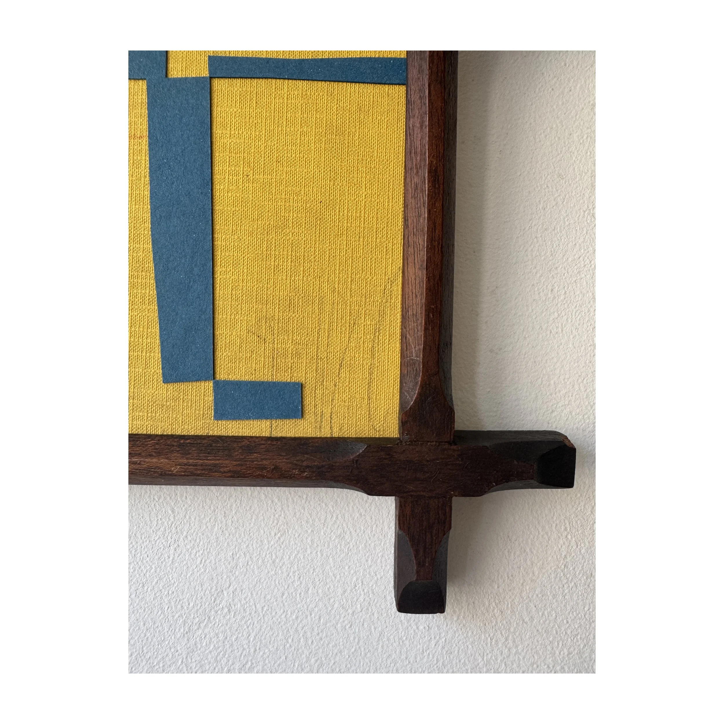 Blue and yellow collage using found materials in a reclaimed vintage frame by British contemporary artist Lauri Hopkins