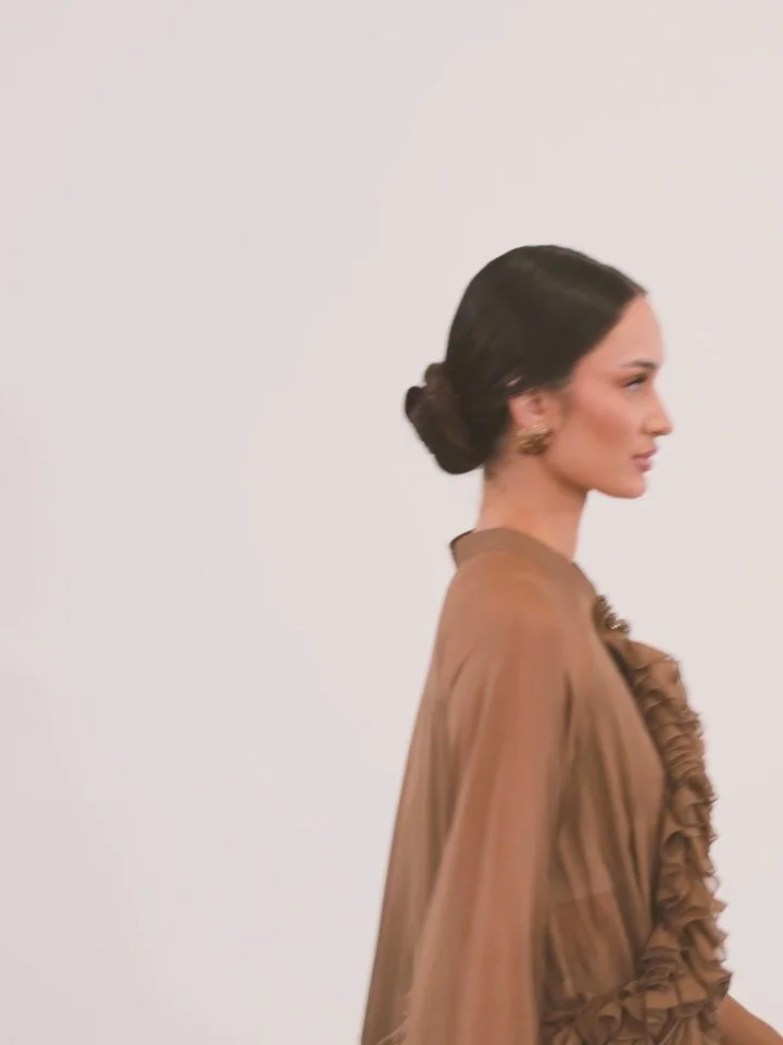 | Fashion &bull; Culture &bull; Legacy

Look 61 &mdash;
From a Vietnamese traditional two-piece silhouette to a romantic, ethereal evening gown.

This cocoa brown silk chiffon &aacute;o d&agrave;i xu&ocirc;ng, paired with matching pants, reimagines t