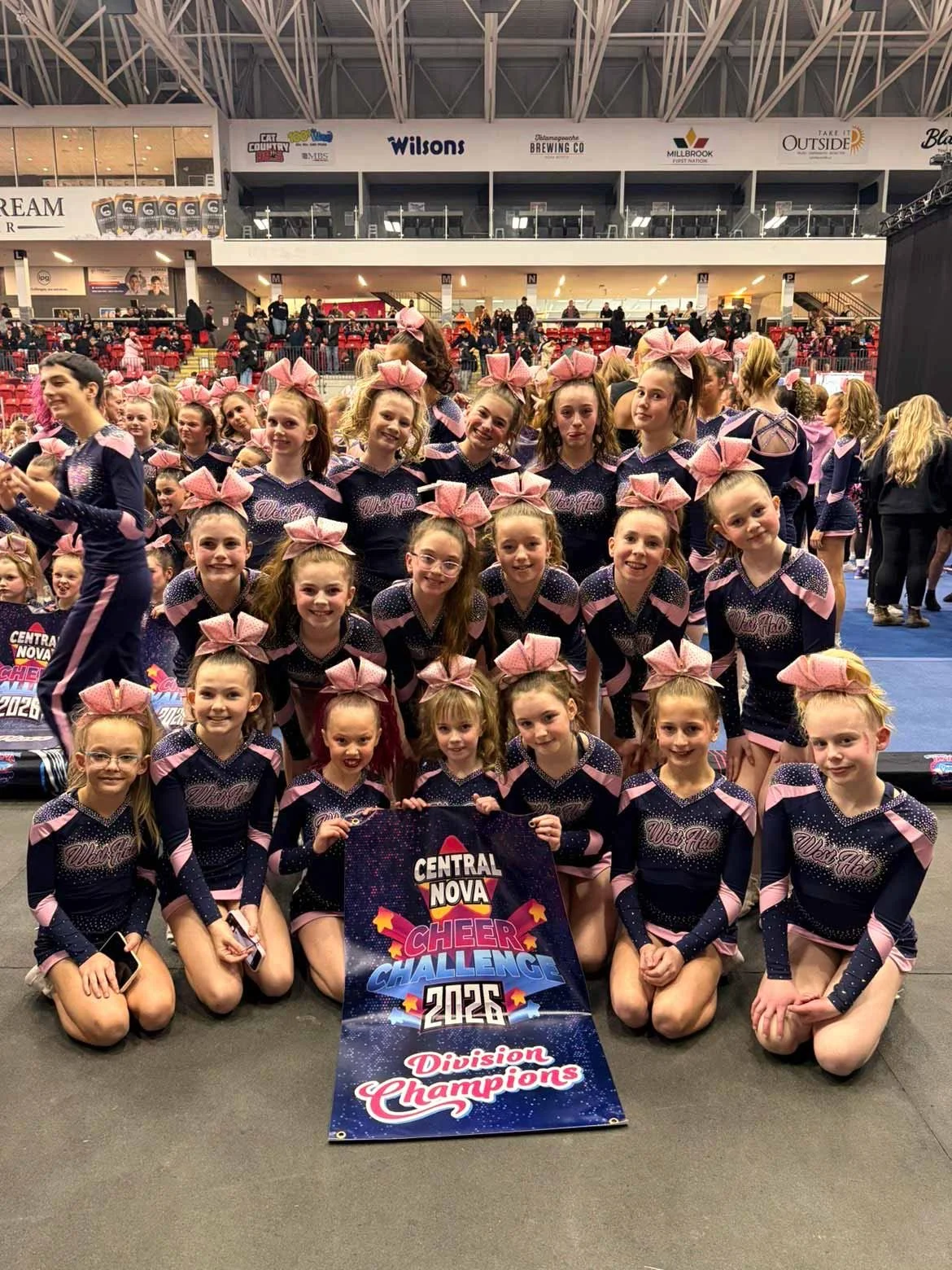 Cheerldeaders with a sign that says Central Nova Cheer Challenge 2026 Division Champions