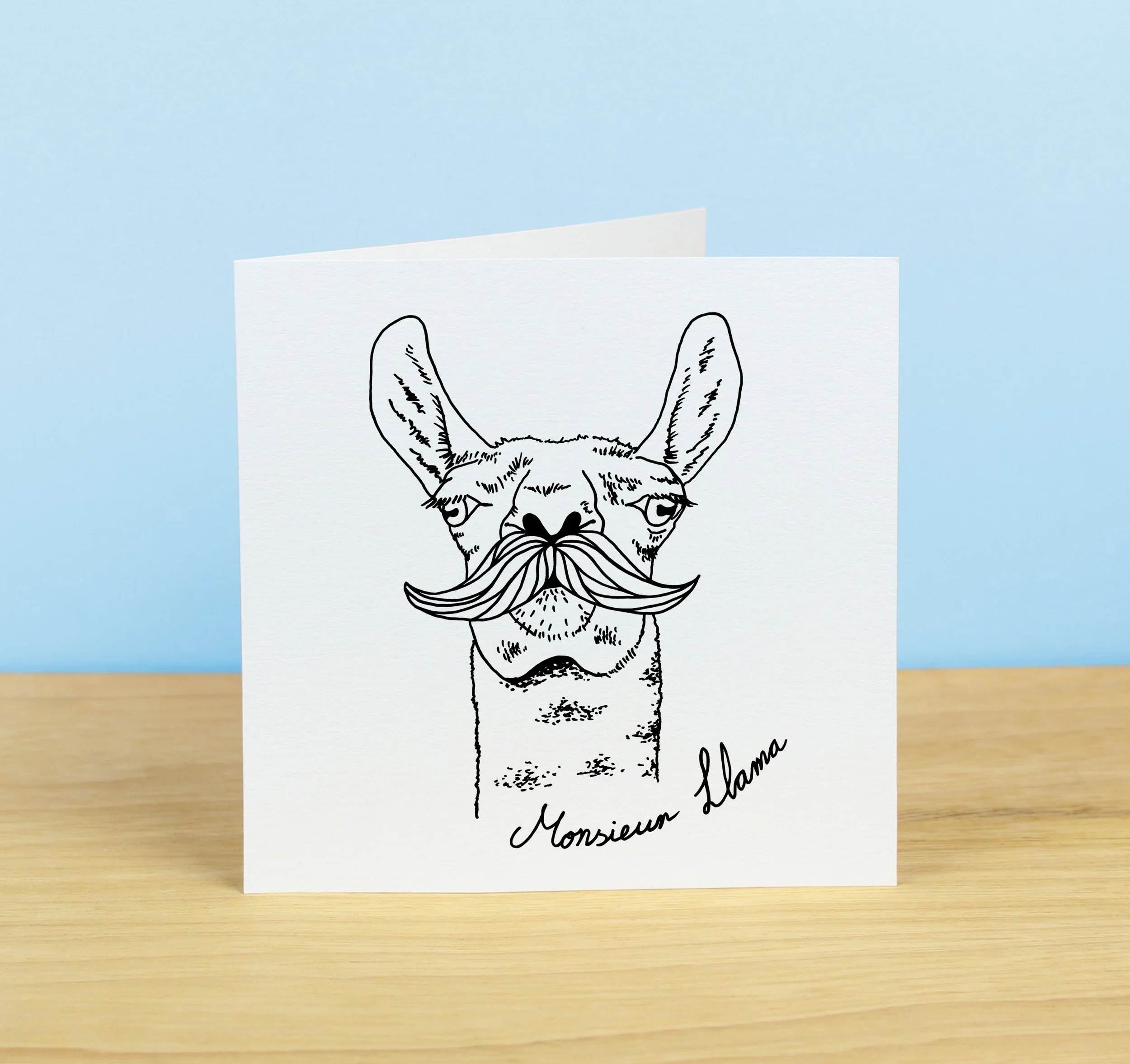 Illustrated greetings card with line drawing of a llama with a moustache