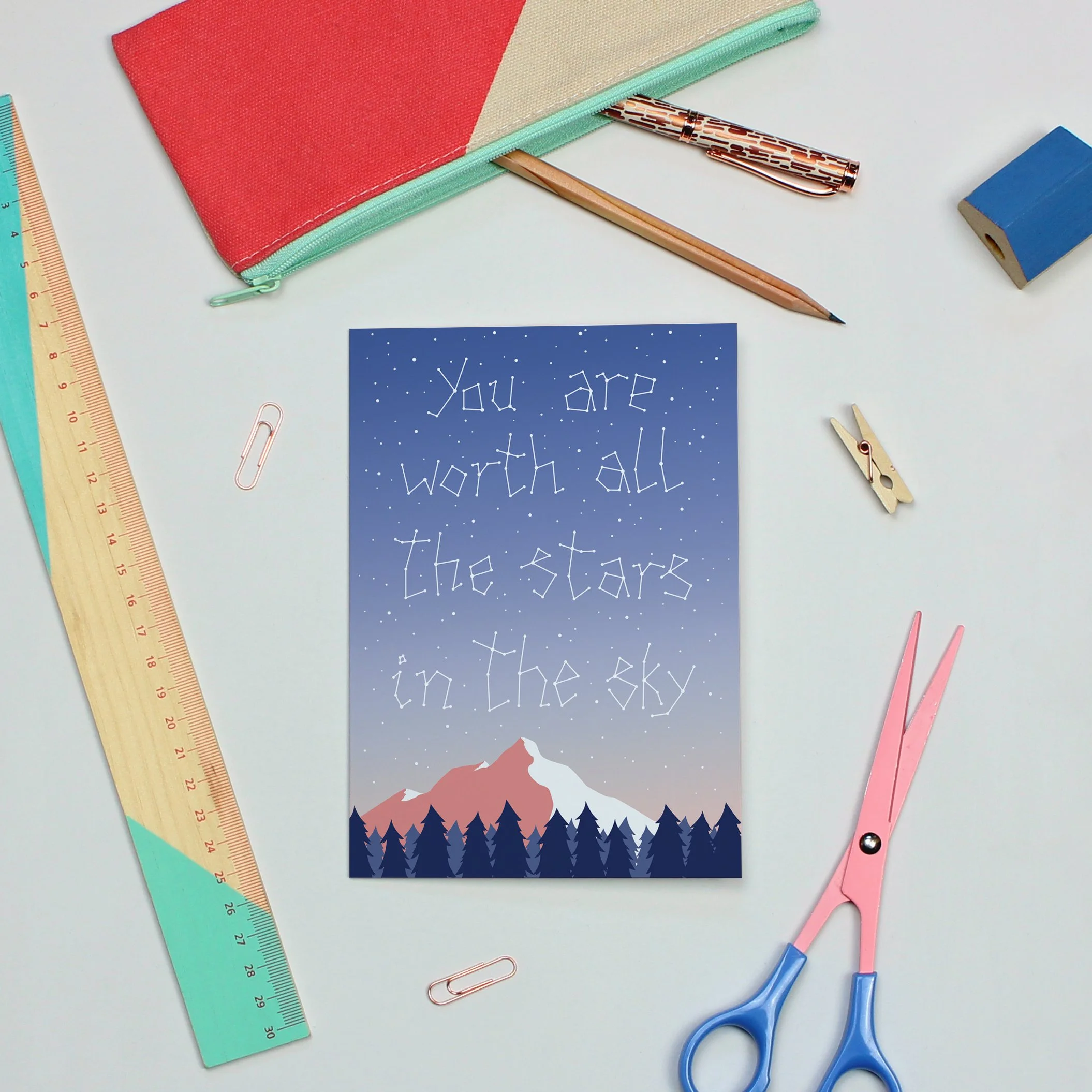 Greetings card with message "You are worth all the stars in the sky" written as a constellation in the sky over a forest and mountain