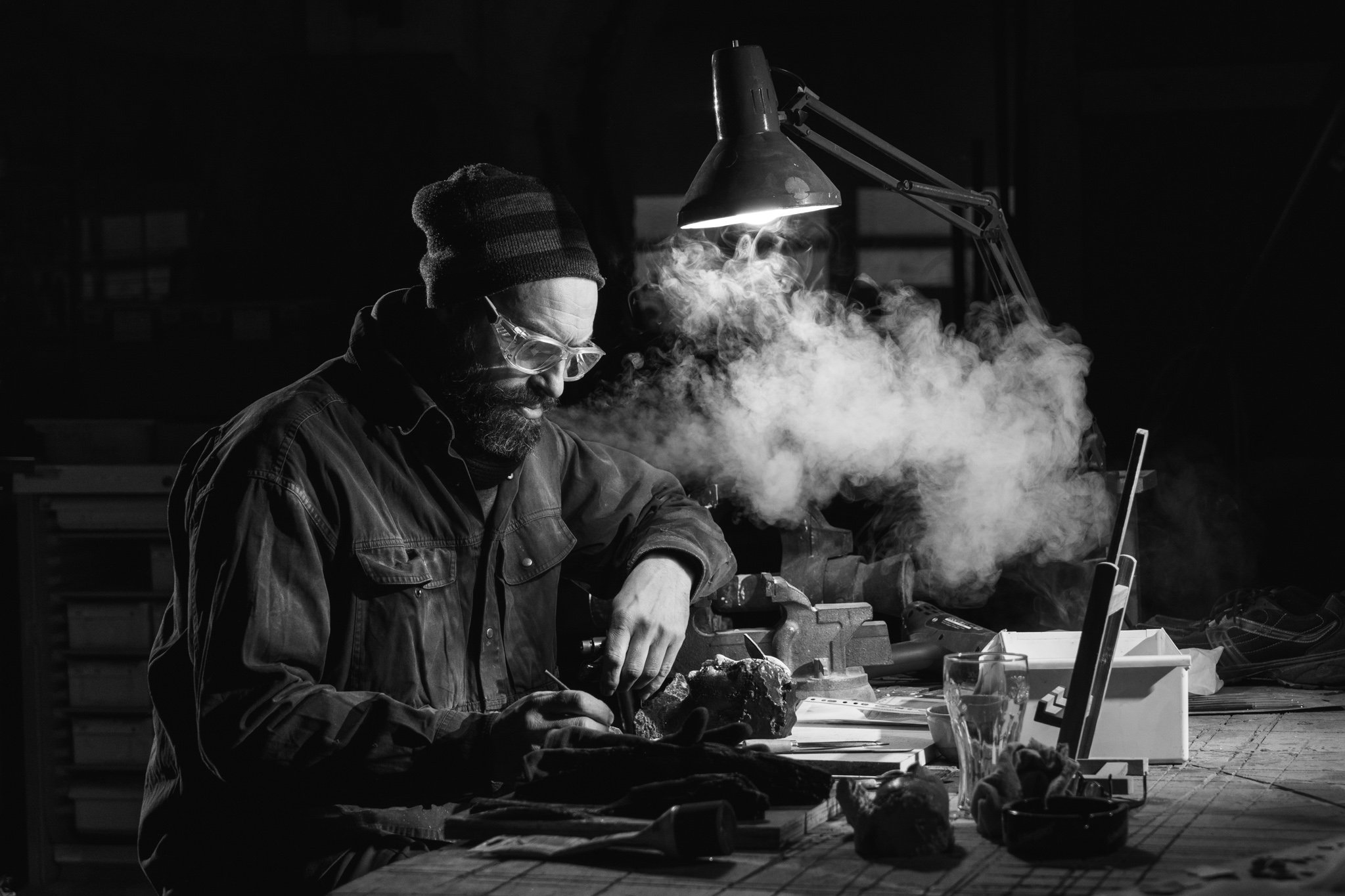 portrait of an artist in his workshop being smoking