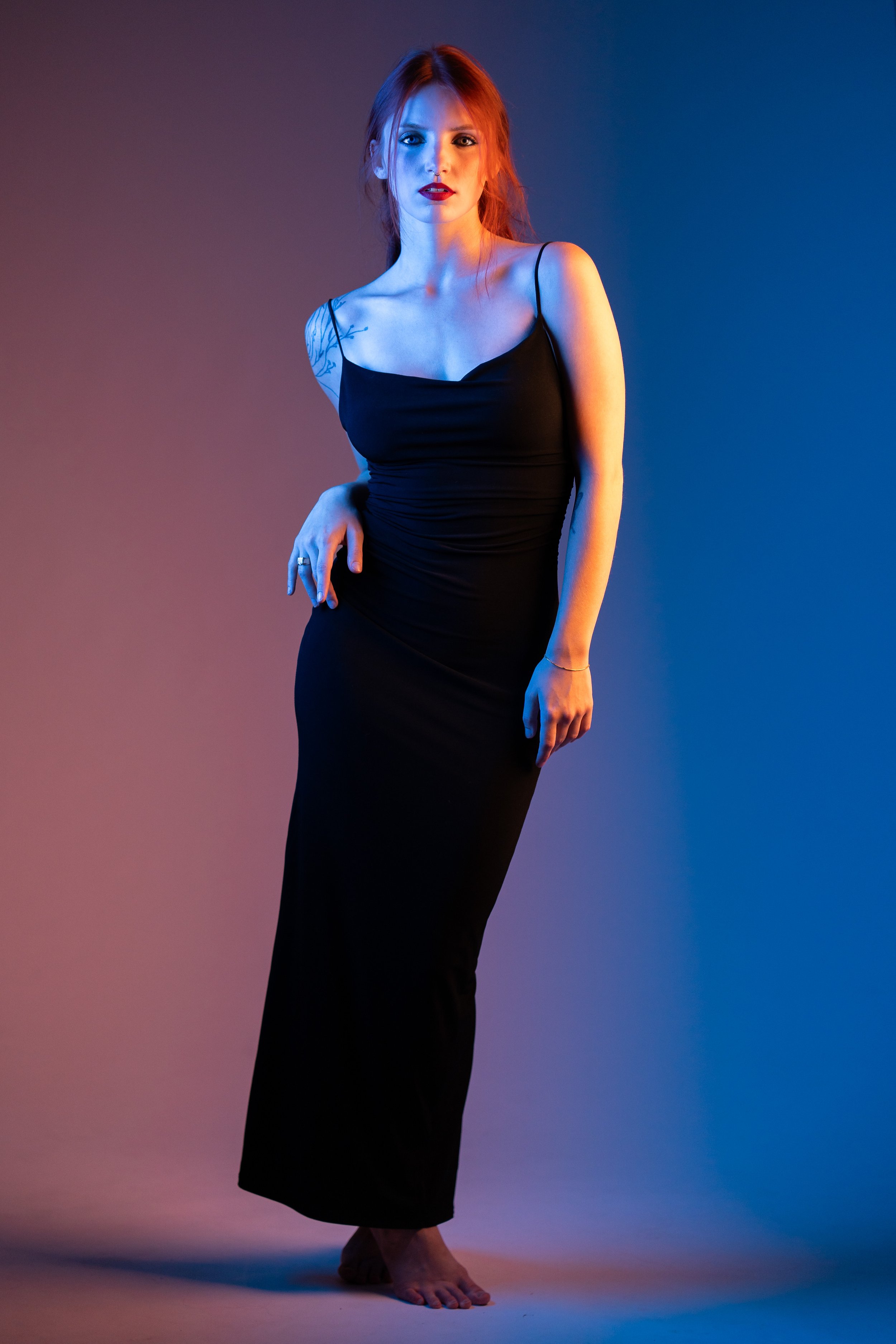 portrait of a girl red head taking the pose with color background