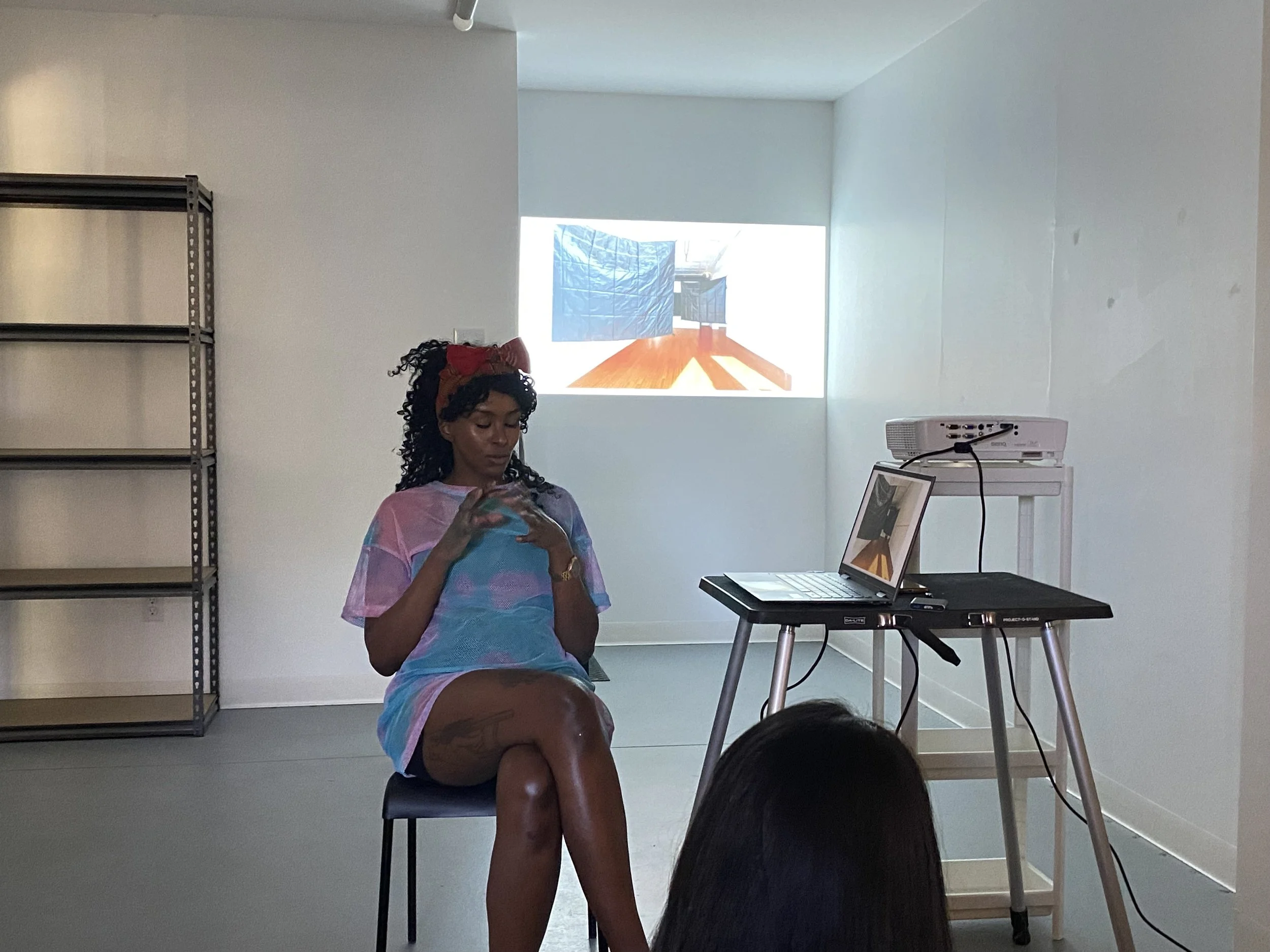 Nura giving an artist presentation