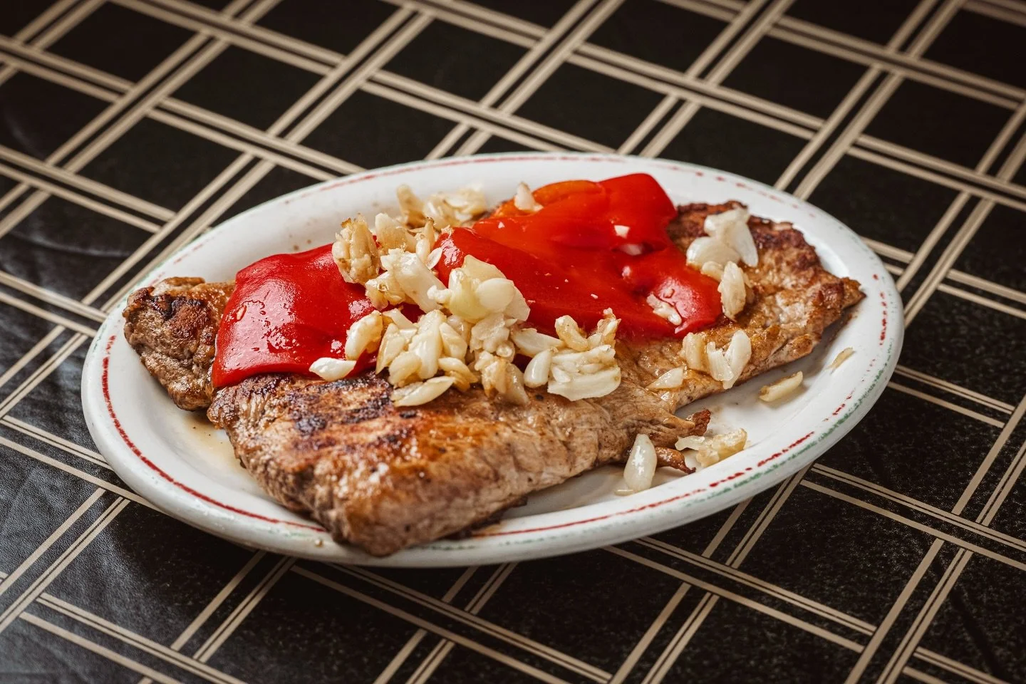 Our pork loin is carefully seasoned, grilled to perfection, and finished with sweet pimento peppers and a generous helping of garlic&mdash;a true Star staple. Give it a try on your next visit!