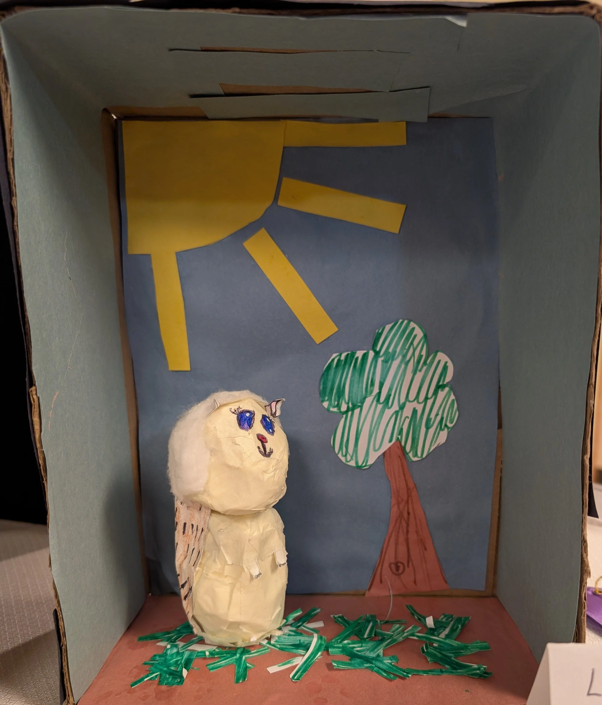 Papier mache Hedgehog in a shadow box forest.