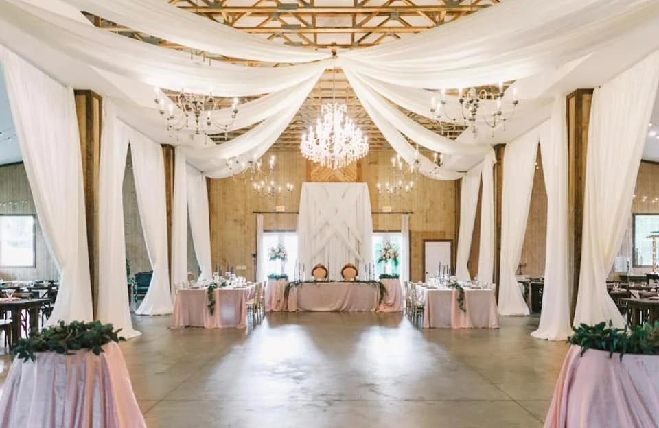 elegant event venue with chandelier and draped fabric
