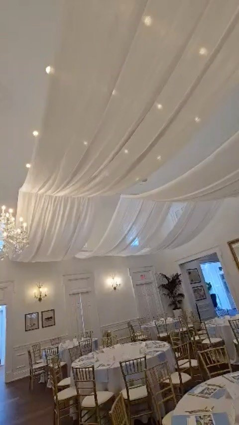 Wedding at Tampa Yacht Club with our Ceiling Wave Drapes, Gold Chiavari Chairs, & Green Hedge Walls. ————————————————————&mdas