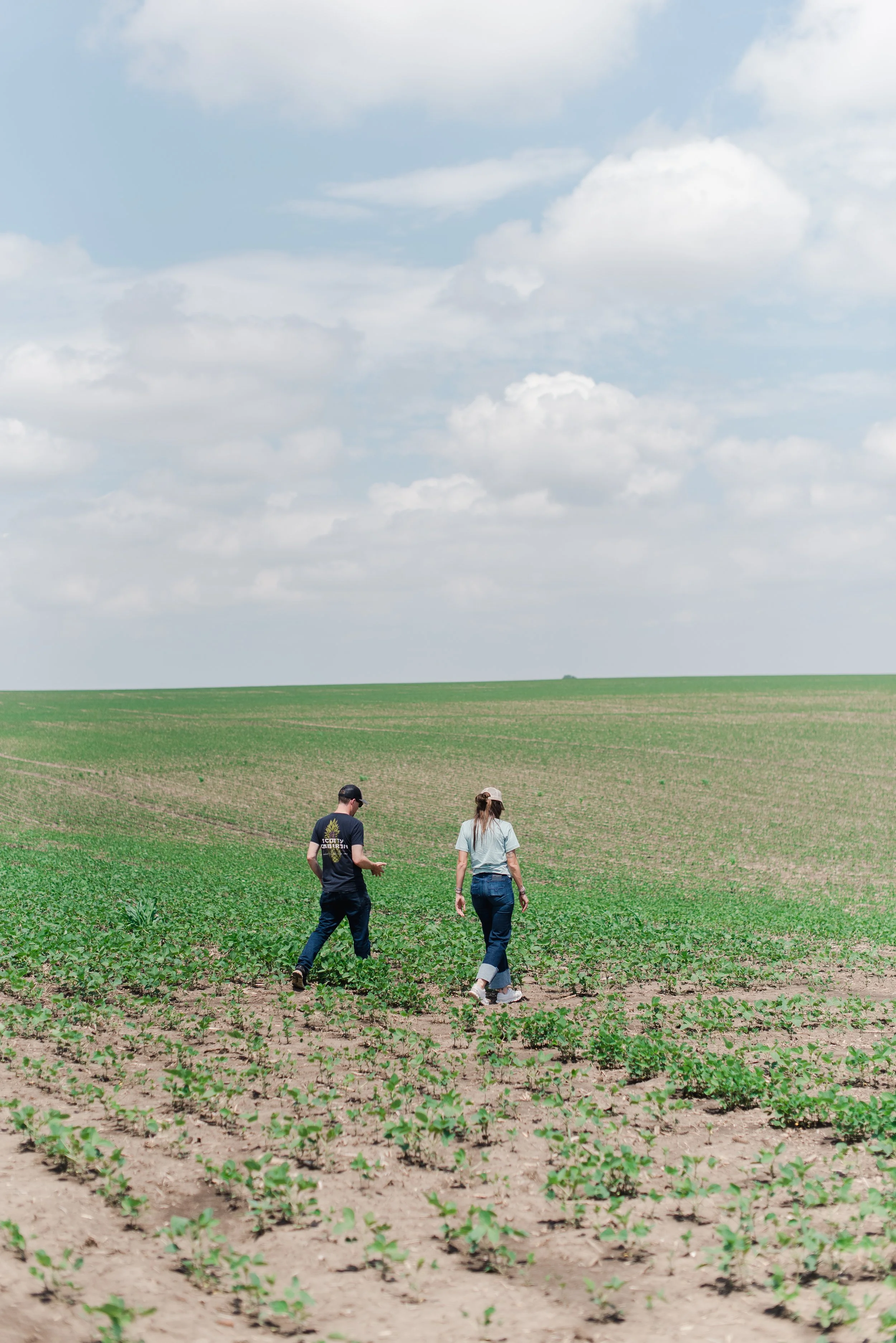 McKenzie and Jordan walking in a bean field