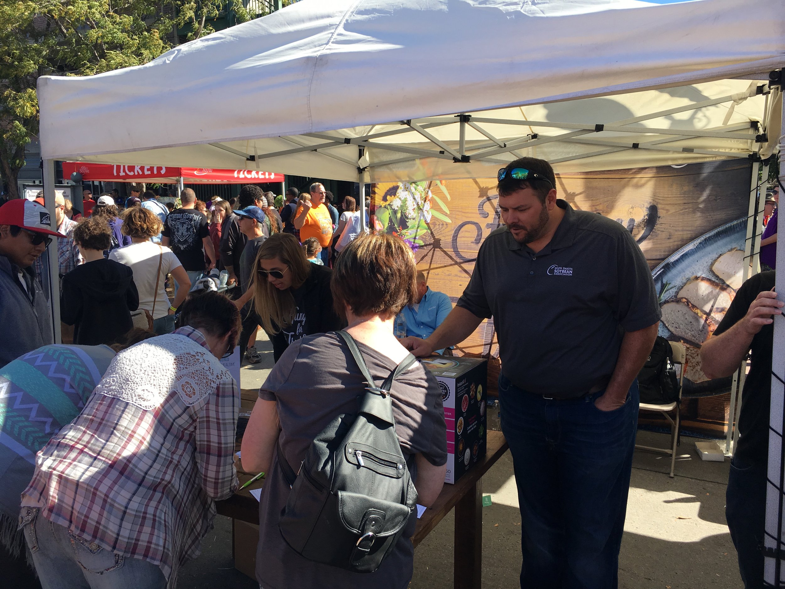 people visiting booth at festival