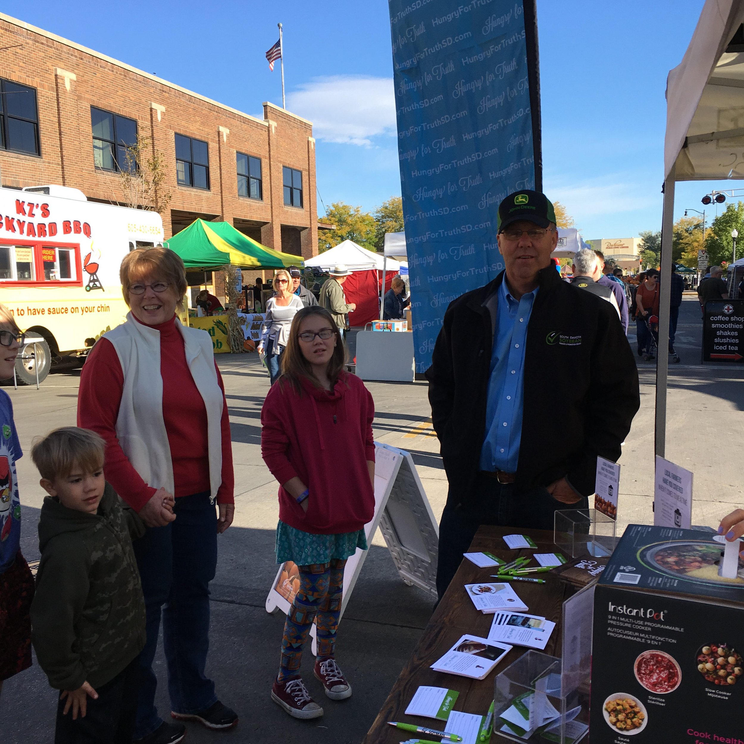 family at booth at festival