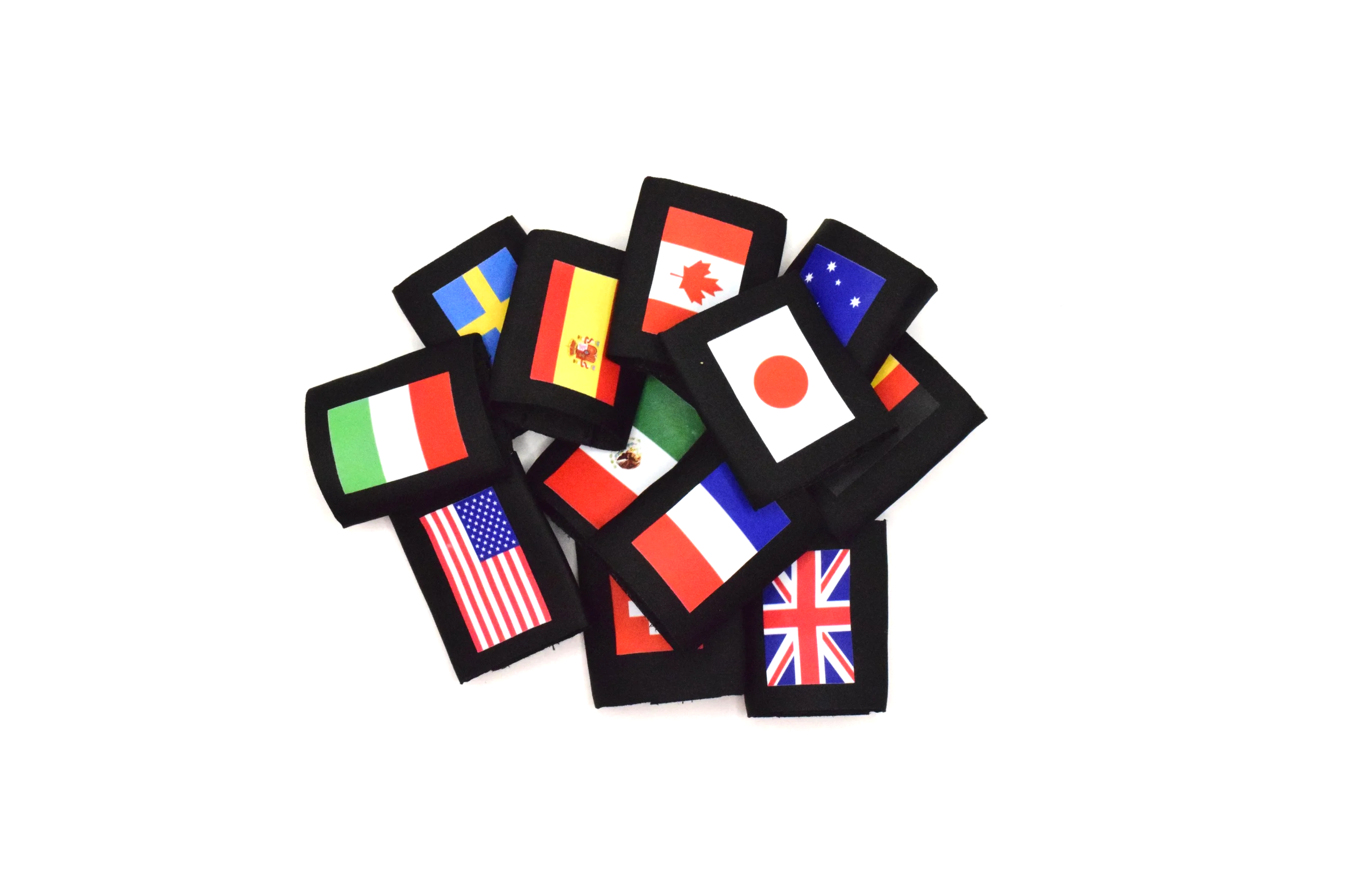 A collection of small fabric patches with various national flags, including the United States, Italy, Japan, the UK, France, Germany, Spain, Canada, Australia, and Sweden, arranged on a plain white background.