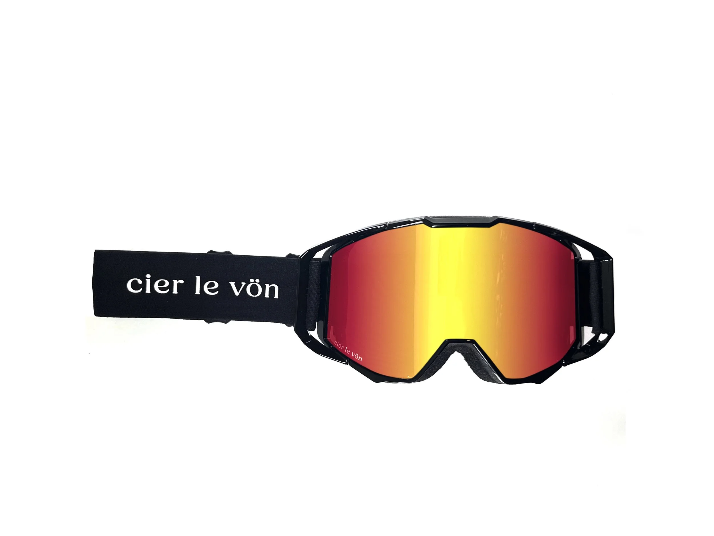A pair of black ski goggles with reflective orange and yellow lenses and a wide black strap with white text reading 'cier le vön'.